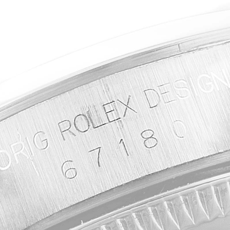 This image shows the side view of the case back of a Rolex Oyster Perpetual 67180 Women's Stainless Steel Black Dial 67180 Women's Stainless Steel Black Dial watch, displaying the engraved model number.