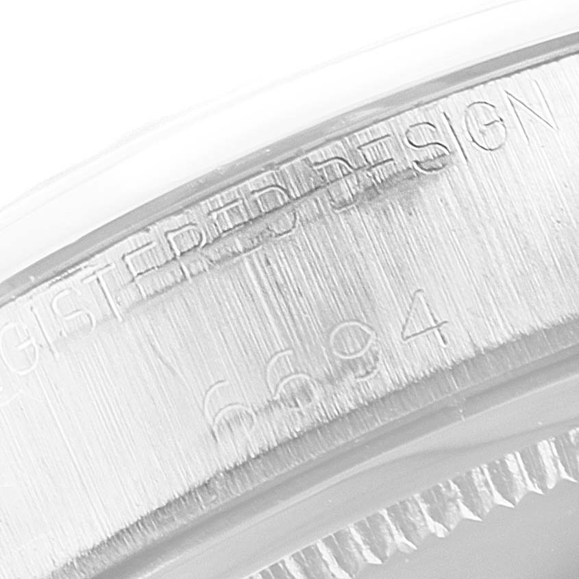 This image shows a close-up of the case back of a Rolex Vintage Collection 6694 Men's Stainless Steel Black Dial 6694 Men's Stainless Steel Black Dial model, revealing its engraved serial number and design details.