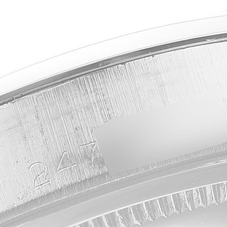 This close-up image shows part of the case and a serial number engraving on the Rolex Vintage Collection 6694 Men's Stainless Steel Black Dial 6694 Men's Stainless Steel Black Dial watch.