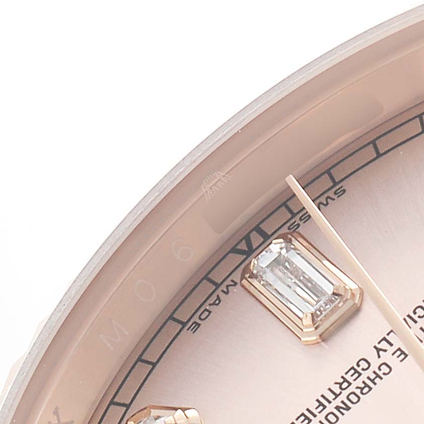 The image shows a close-up of the Rolex President 118235 Men's Rose Gold Pink Dial model watch, highlighting a portion of the dial, bezel, and diamond hour markers.