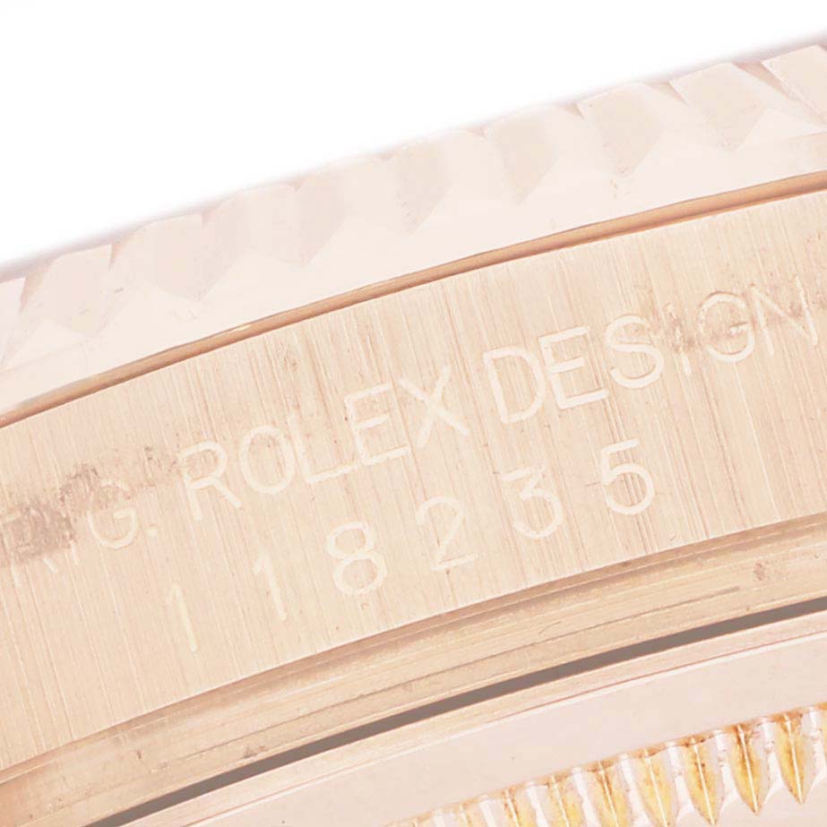 The image shows a close-up of the case side engraving on a Rolex President 118235 Men's Rose Gold Pink Dial model.
