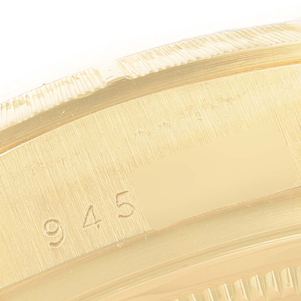 This close-up image shows the edge and part of the caseback of a Rolex President 18078 Men
s Yellow Gold Silver Dial 18078 Men
s Yellow Gold Silver Dial model.