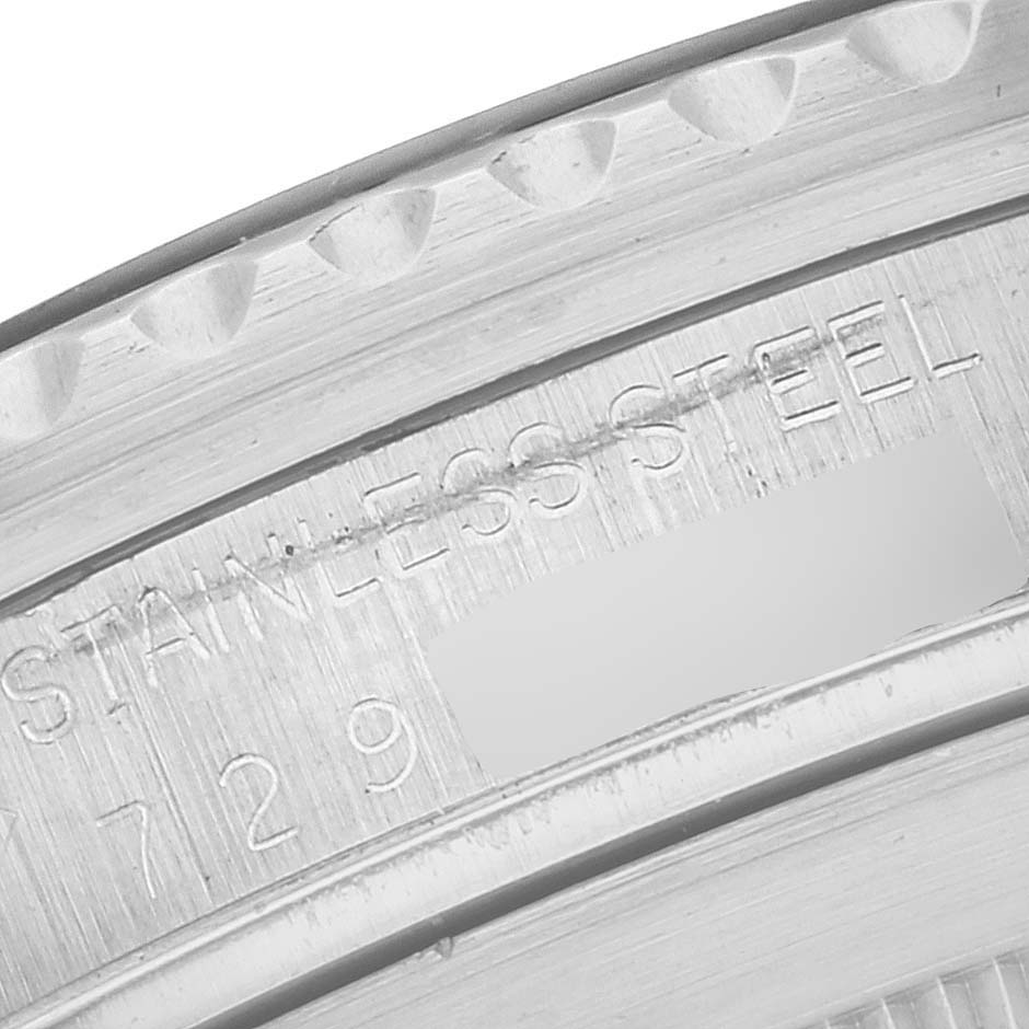 This close-up image of a Vintage Collection Rolex watch shows part of the case with "STAINLESS STEEL" and partial serial number engraving.