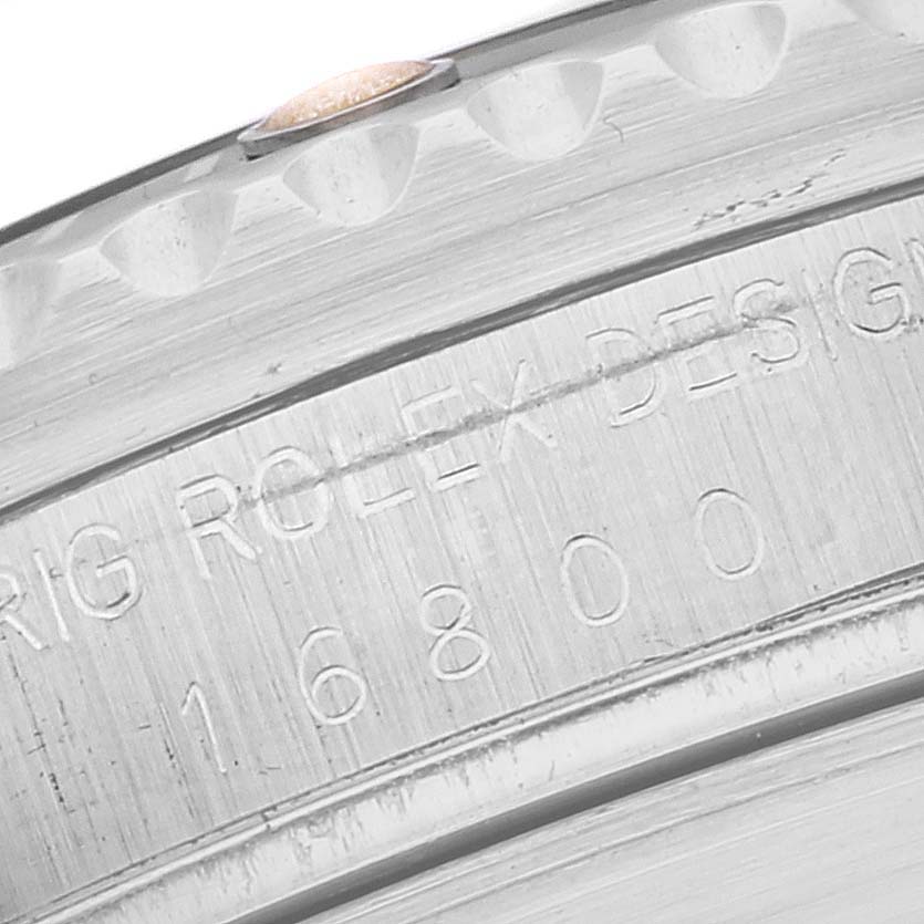 The image shows a close-up of the side of a Rolex Vintage Collection 16800 Men's Stainless Steel Black Dial 16800 Men's Stainless Steel Black Dial model watch, featuring its engraved serial number and branding.