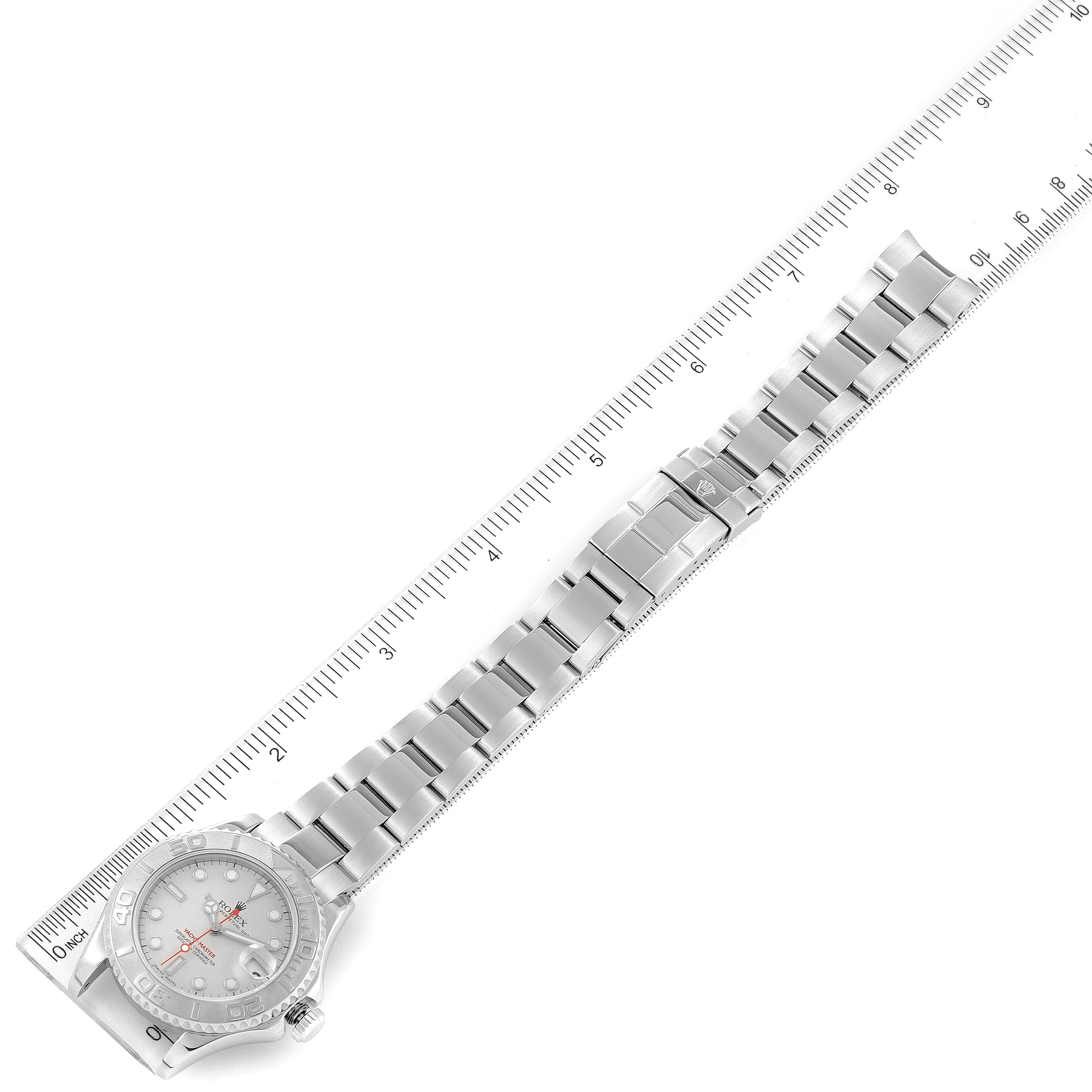 The Rolex Yacht-Master 168622 Men's Stainless Steel Silver Dial 168622 Men's Stainless Steel Silver Dial watch is shown from a top-down angle, along with its bracelet and clasp next to a ruler for scale.