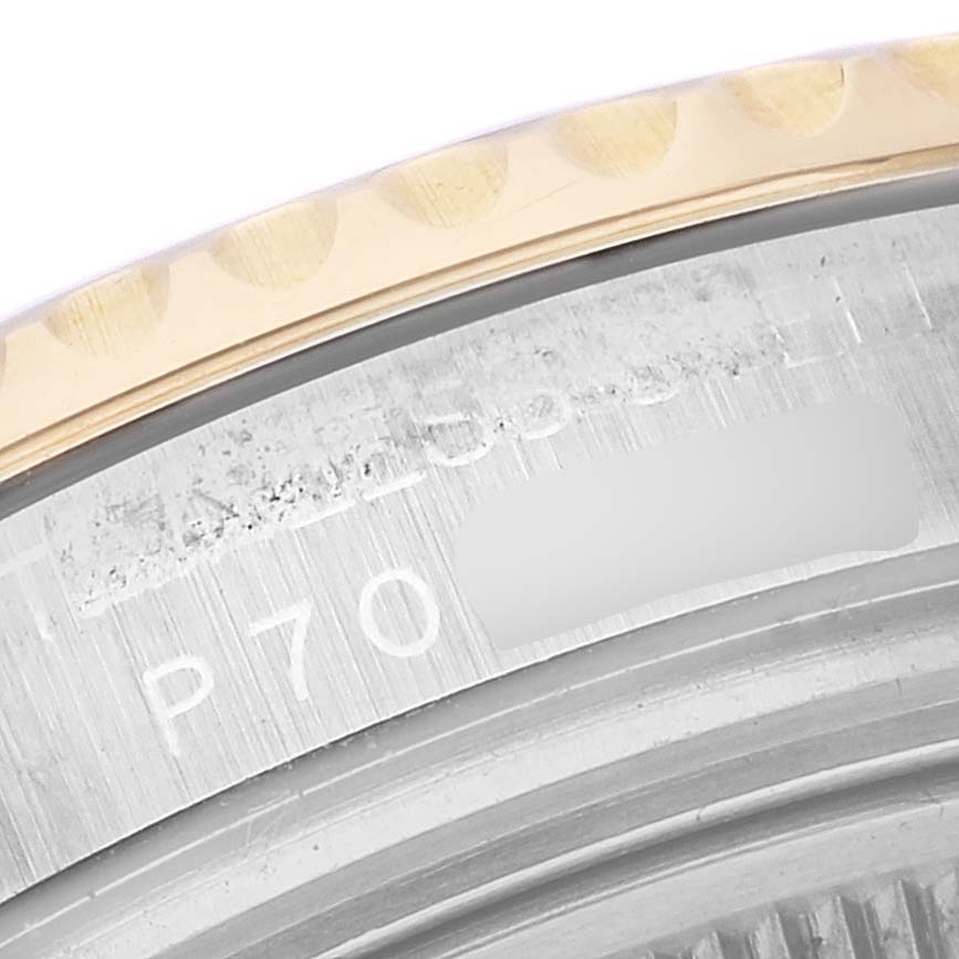 This close-up image shows the side view of the bezel and part of the serial number on the Rolex Yacht-Master 168623 Men's Steel and Gold (two tone) White Dial 168623 Men's Steel and Gold (two tone) White Dial watch.