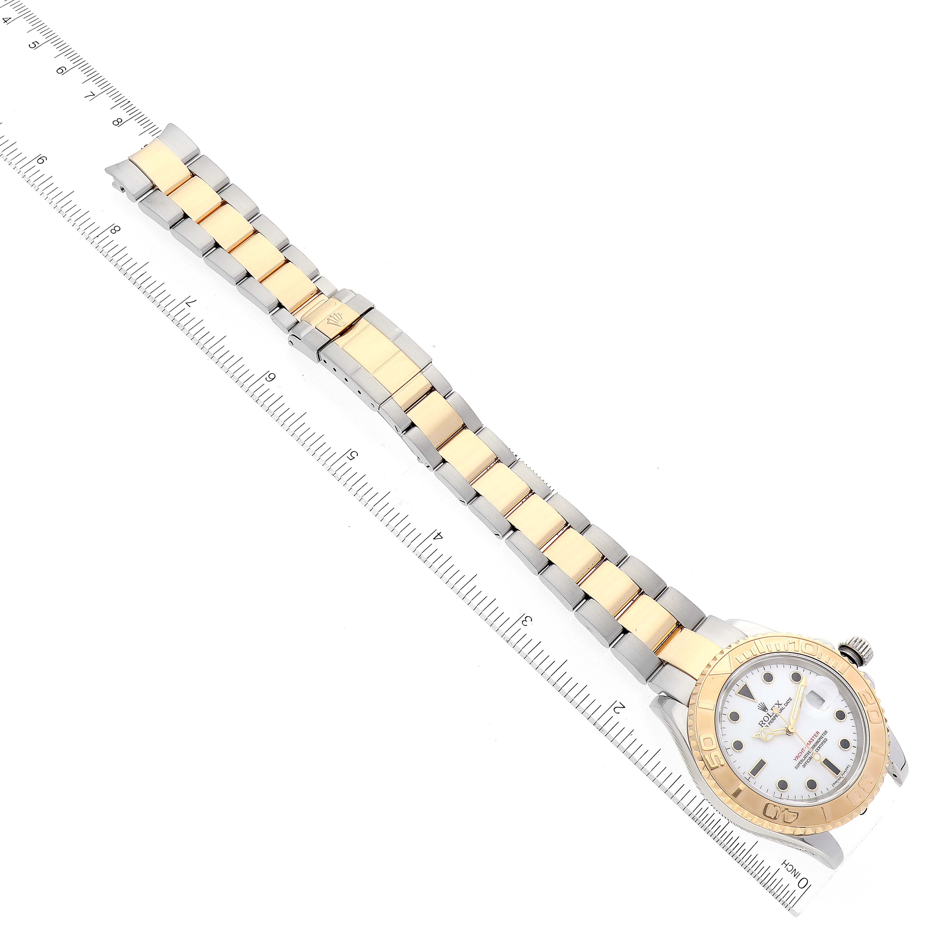 The image shows a Rolex Yacht-Master 16623 Men's Steel and Gold (two tone) White Dial 16623 Men's Steel and Gold (two tone) White Dial watch from a top-down angle, featuring its bracelet, clasp, bezel, and dial.