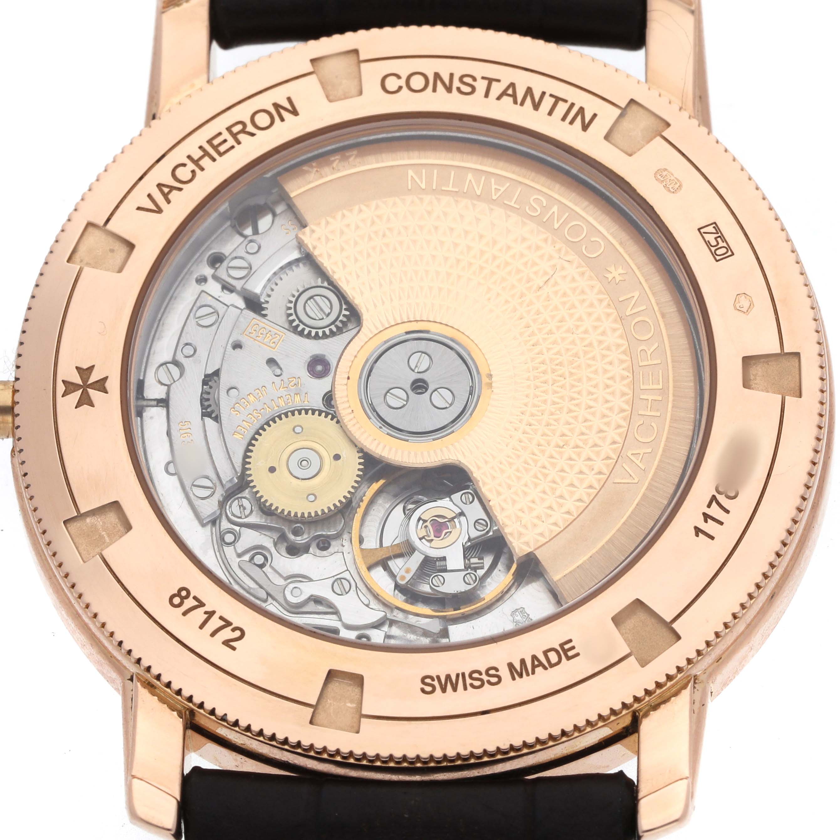 The Vacheron Constantin Traditionnelle 87172 Men's Rose Gold Silver Dial watch is shown from the back, highlighting its intricate movement and case engravings.