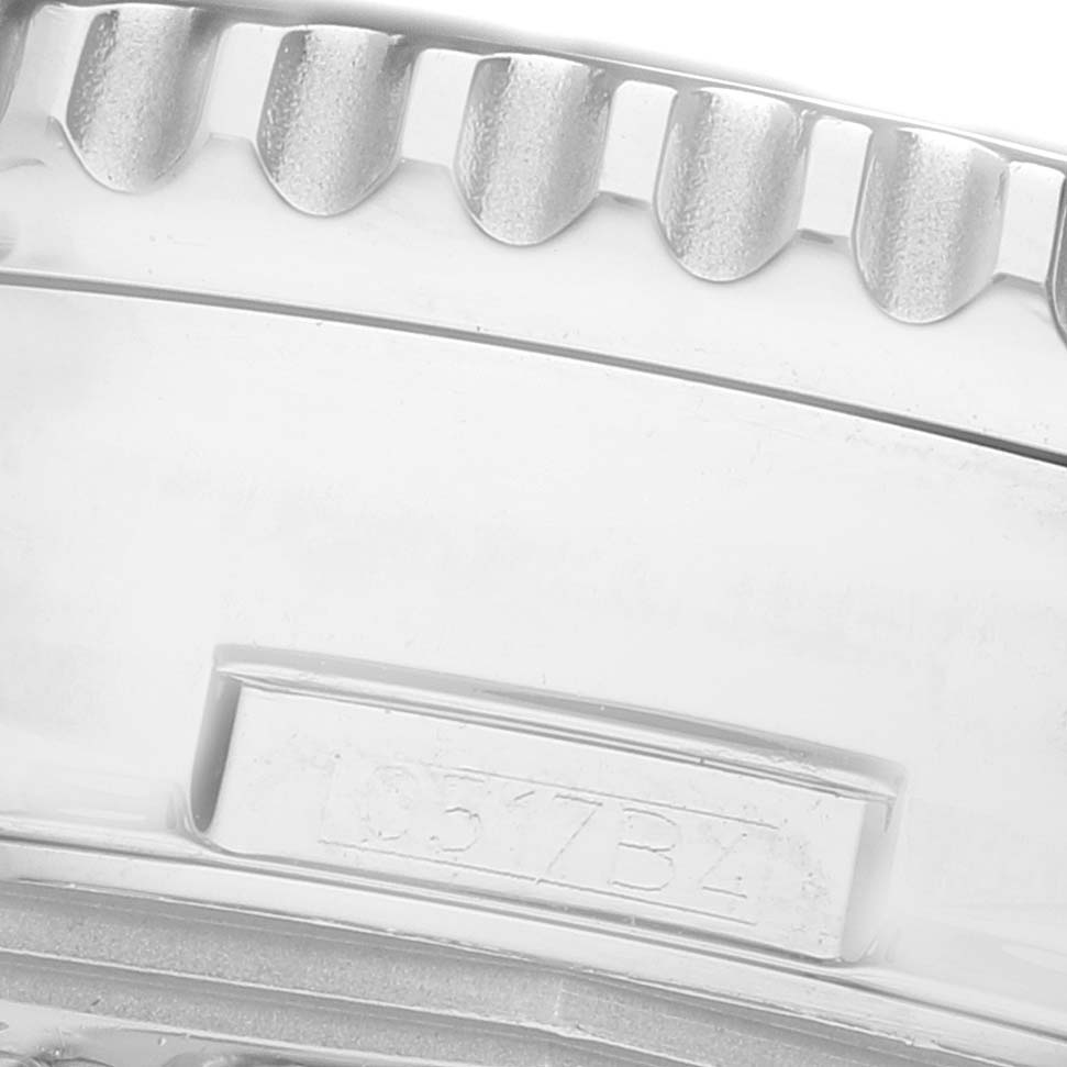 The image shows a close-up of the bezel edge and part of the bracelet of a Breitling Navitimer AB0127 Men's Stainless Steel Black Dial watch, highlighting its engraved detail.