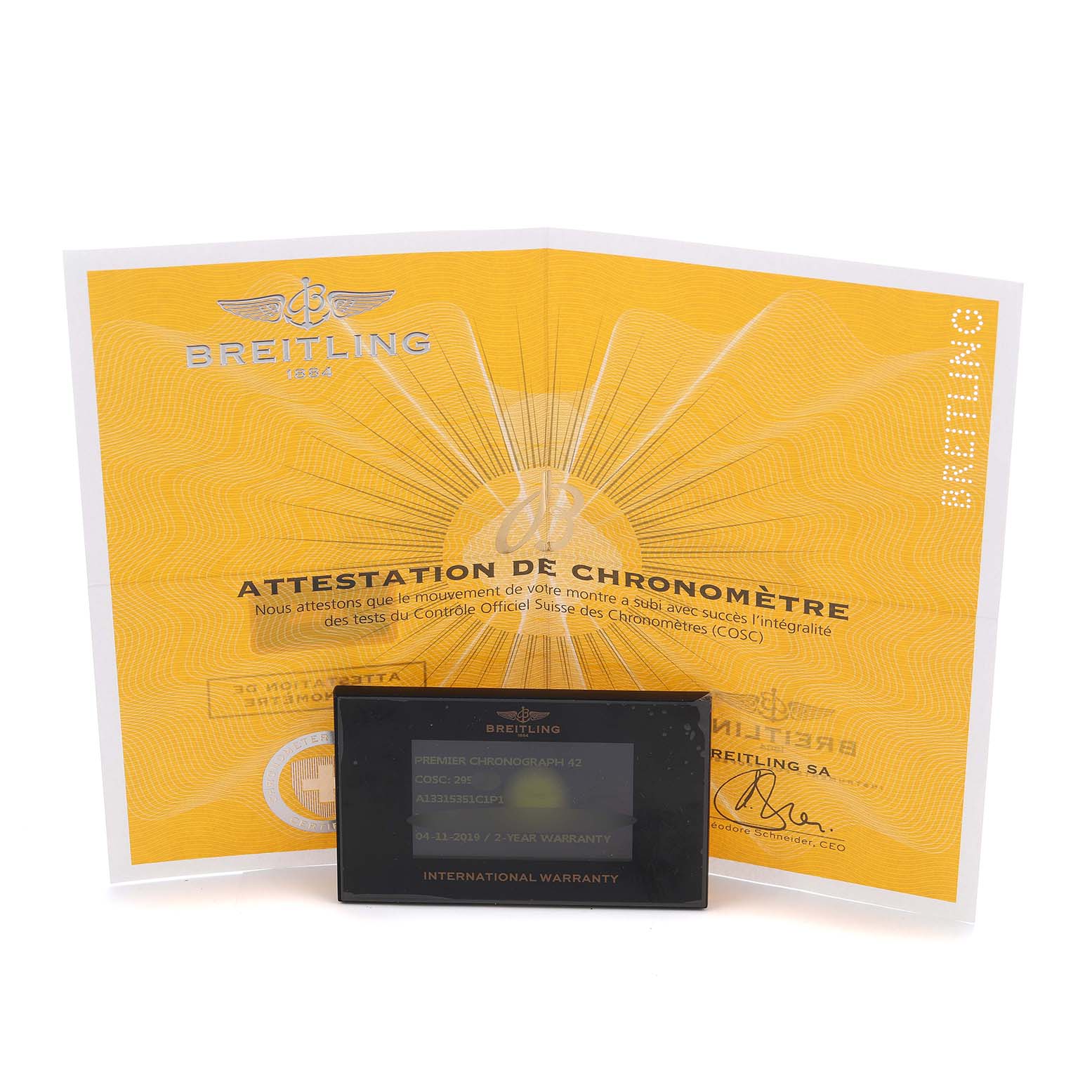 The image shows a Breitling Premier A13315 Men's Stainless Steel Blue Dial model certificate and international warranty card at an upright angle.