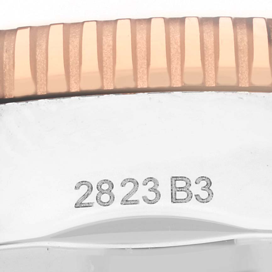 The image shows the edge and serial number of a Breitling Superocean UB2030 Men's Steel and Gold (two tone) Black Dial UB2030 Men's Steel and Gold (two tone) Black Dial watch case at a close-up angle.