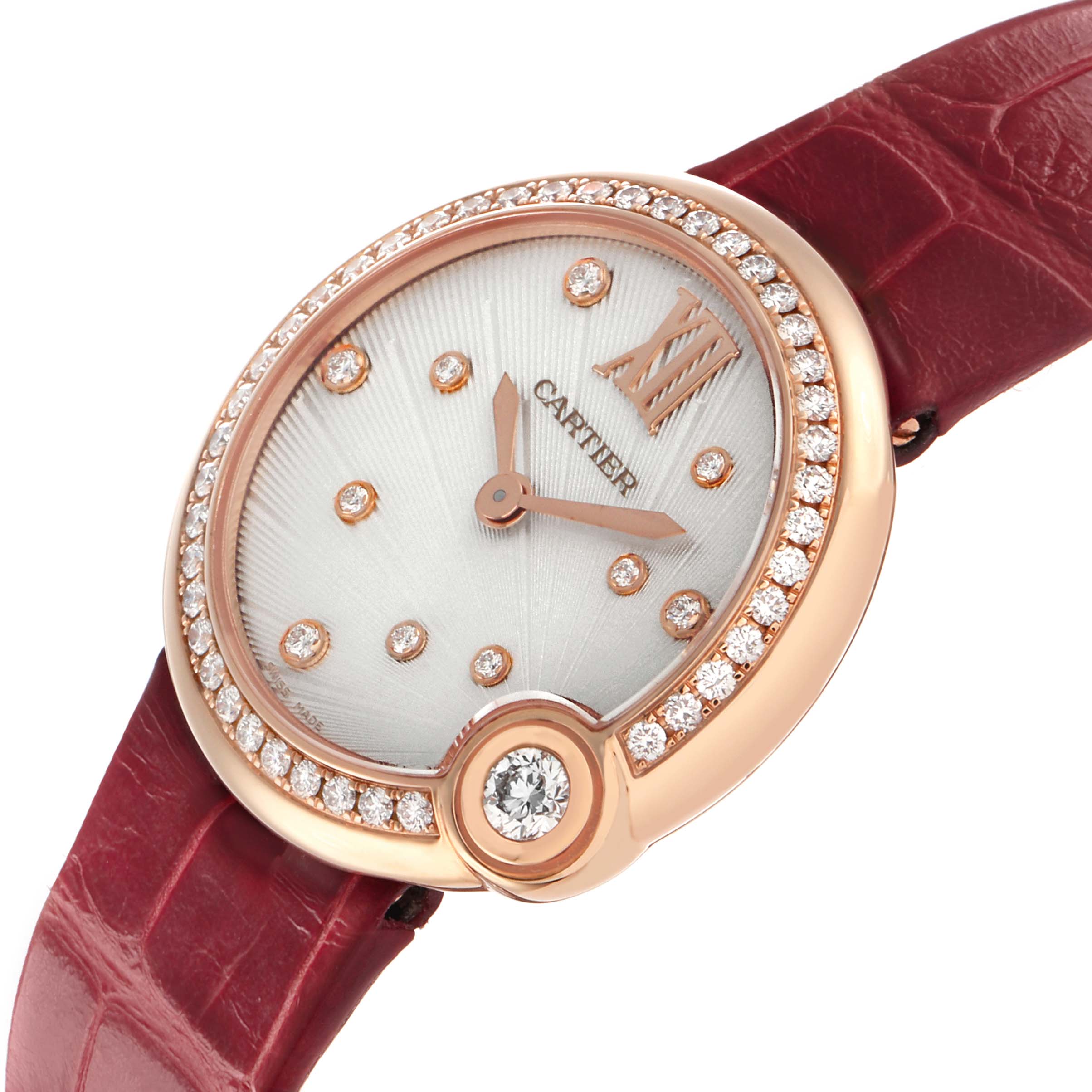 The Cartier Ballon Blanc WJBL0012 Women's Rose Gold Silver Dial watch is shown at an angled view, highlighting its diamond-studded bezel, red leather strap, and elegant dial.