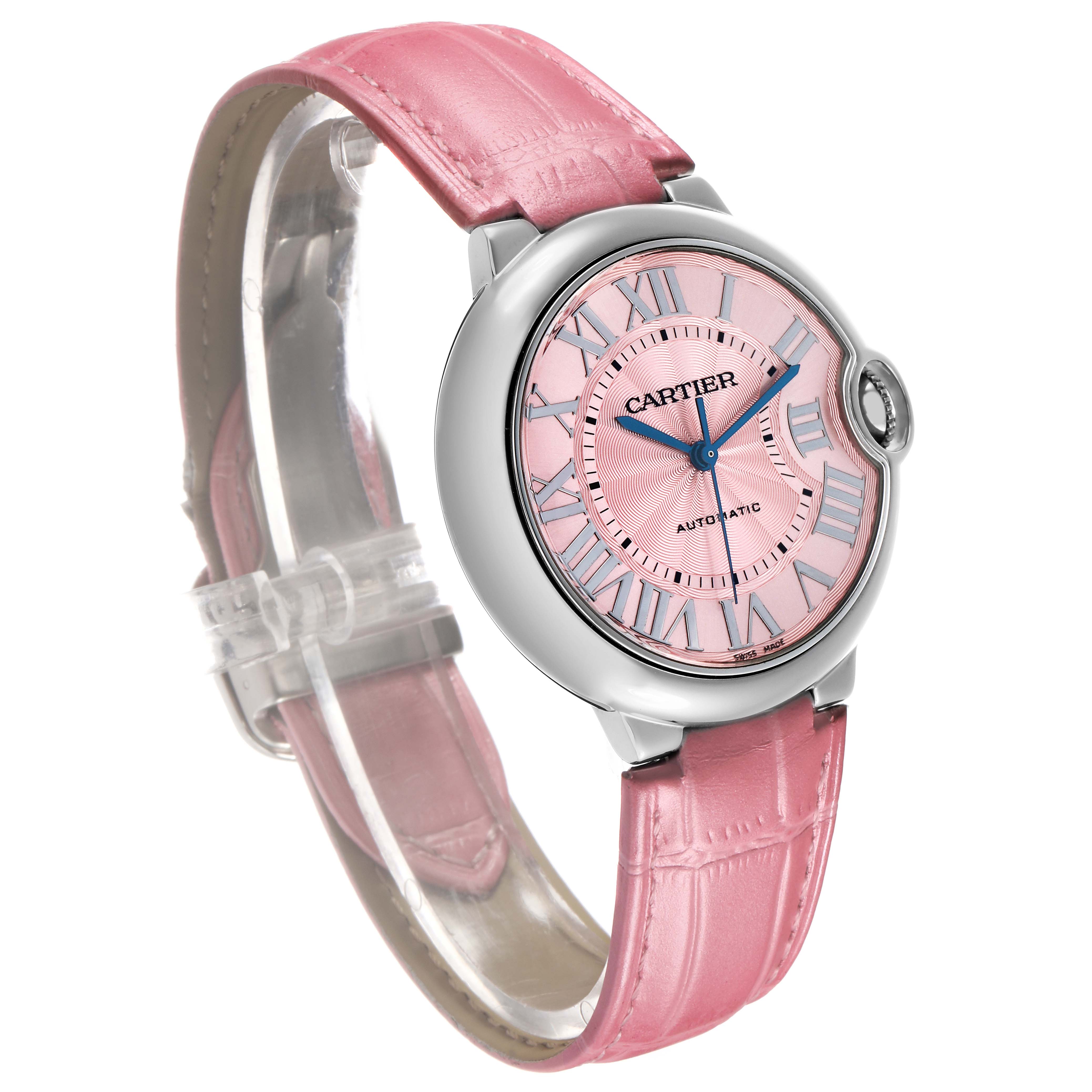 The Cartier Ballon Bleu WSBB0007 Women's Stainless Steel Pink Dial watch is shown at an angled view, highlighting the pink dial, Roman numerals, and pink leather strap.