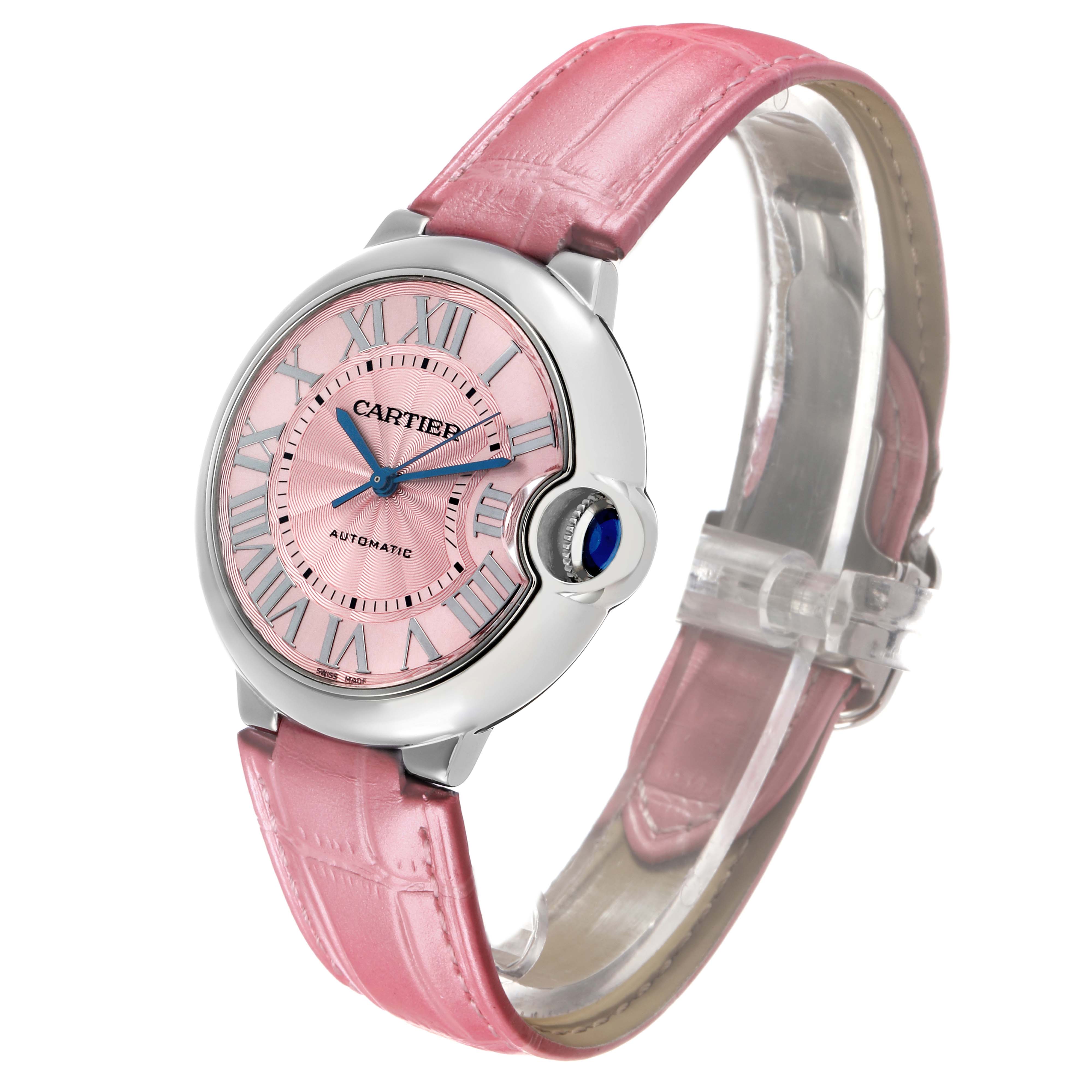 The Cartier Ballon Bleu WSBB0007 Women's Stainless Steel Pink Dial watch is shown at a three-quarter angle, displaying its pink dial, Roman numerals, and pink leather strap.