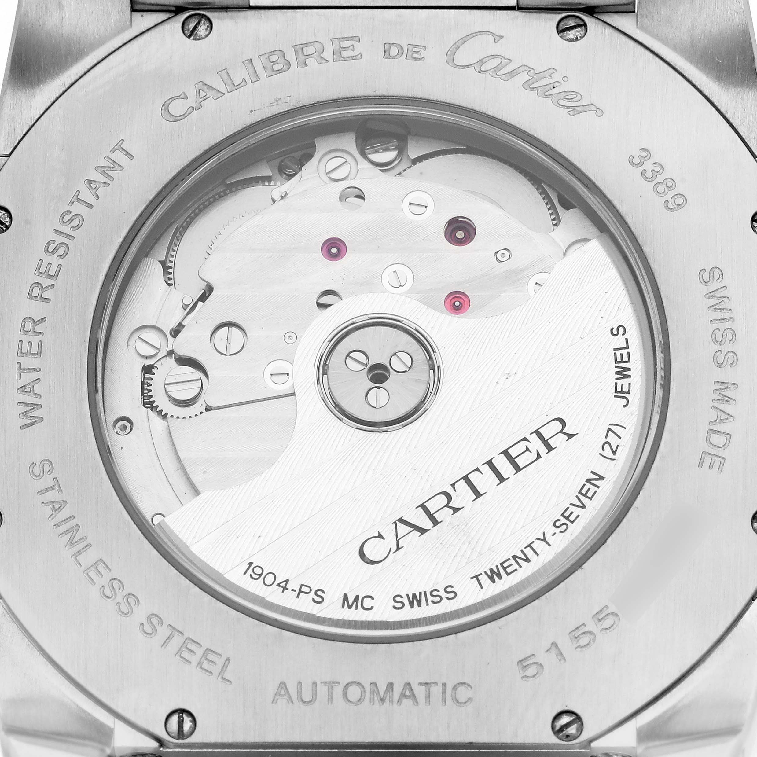 The image shows the back view of a Calibre de Cartier watch, highlighting its automatic movement and internal mechanics.