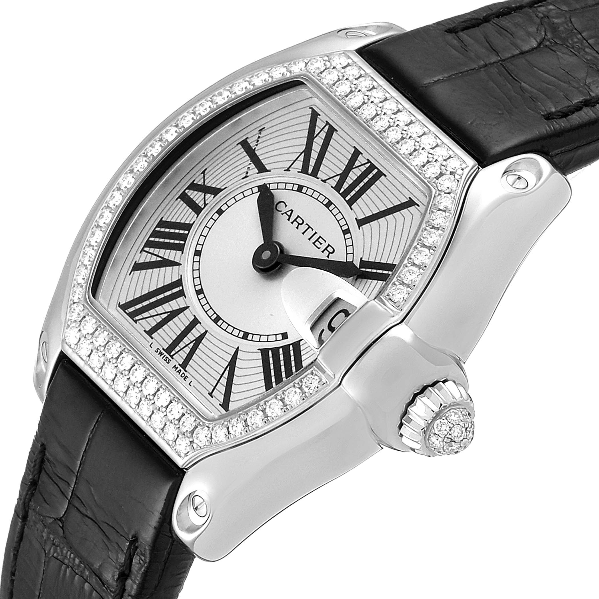 The Cartier Roadster WE500260 Women
s White Gold Silver Dial WE500260 Women
s White Gold Silver Dial watch is shown from an angle highlighting its dial, diamond bezel, crown, and part of the black leather strap.
