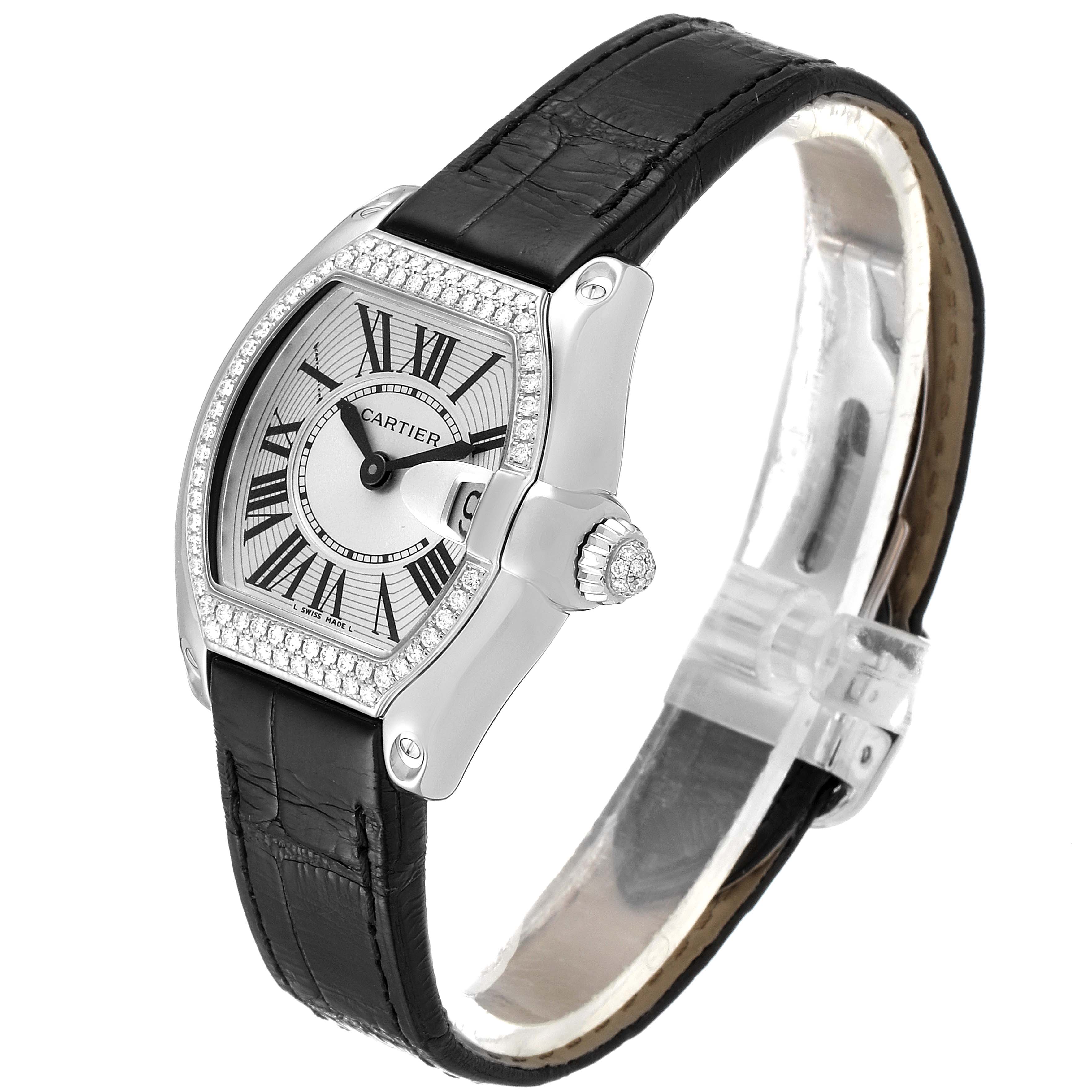 The Cartier Roadster WE500260 Women
s White Gold Silver Dial WE500260 Women
s White Gold Silver Dial watch is shown at a slight angle, displaying its face, bezel, crown, and black leather strap.