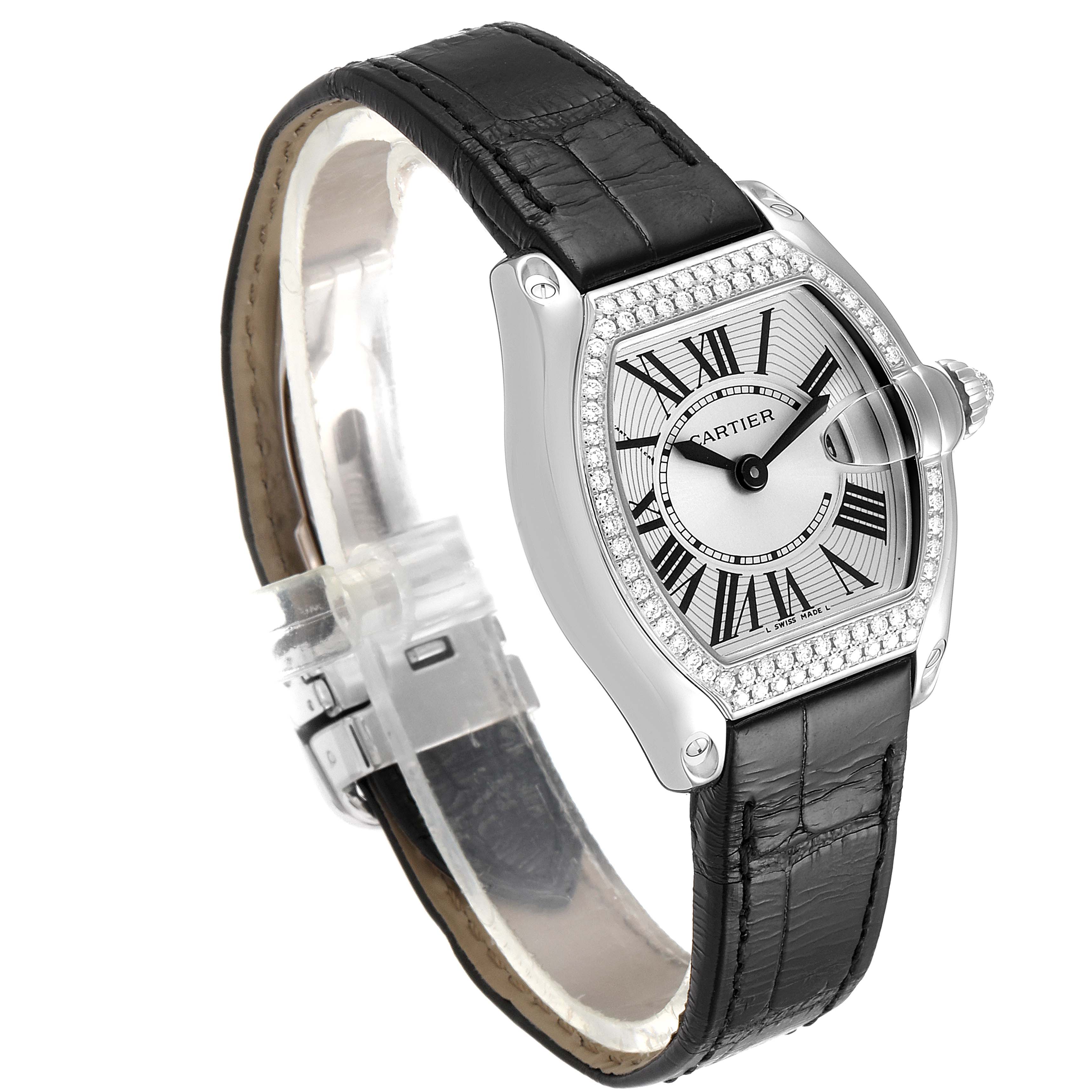 This image shows an angled view of a Cartier Roadster WE500260 Women
s White Gold Silver Dial WE500260 Women
s White Gold Silver Dial watch, highlighting its black leather strap, silver dial, Roman numerals, and diamond bezel.