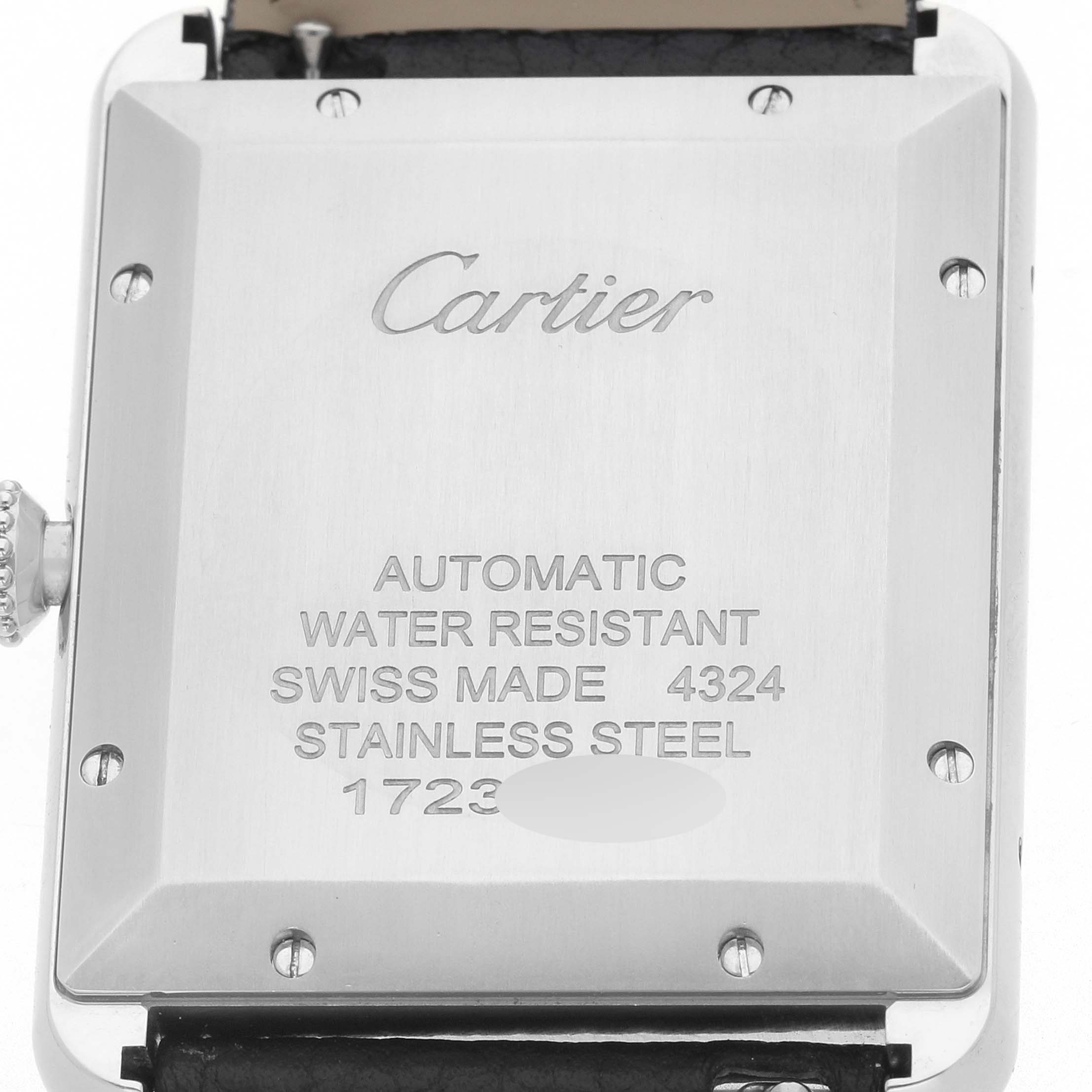 The image shows the back of a Cartier Tank Must WSTA0040 Men's Stainless Steel Silver Dial watch, highlighting engravings and the crown.