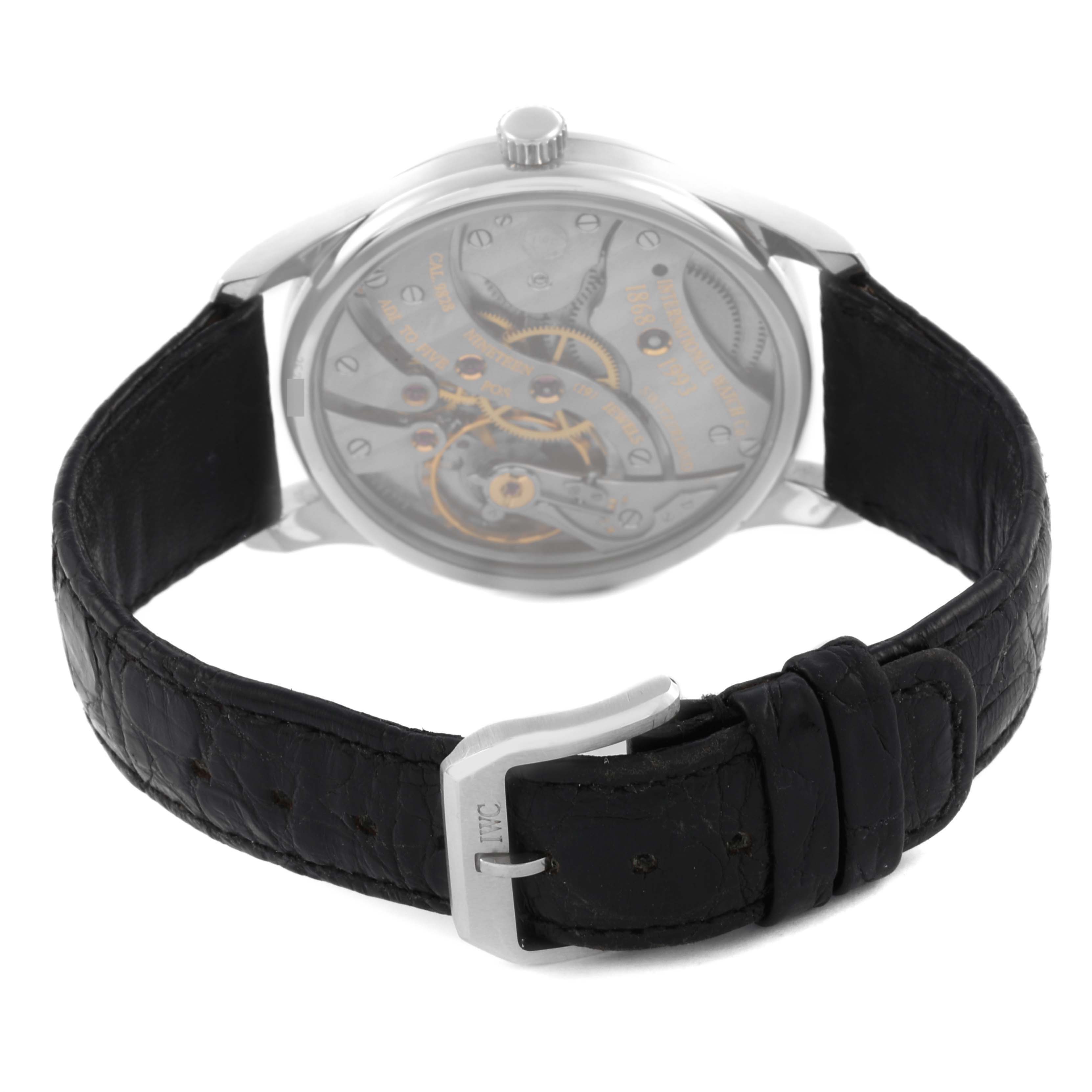 The IWC Portuguese IW5441 Men
s Stainless Steel Silver Dial IW5441 Men
s Stainless Steel Silver Dial watch is shown from the back, displaying the movement and black leather strap with a clasp.