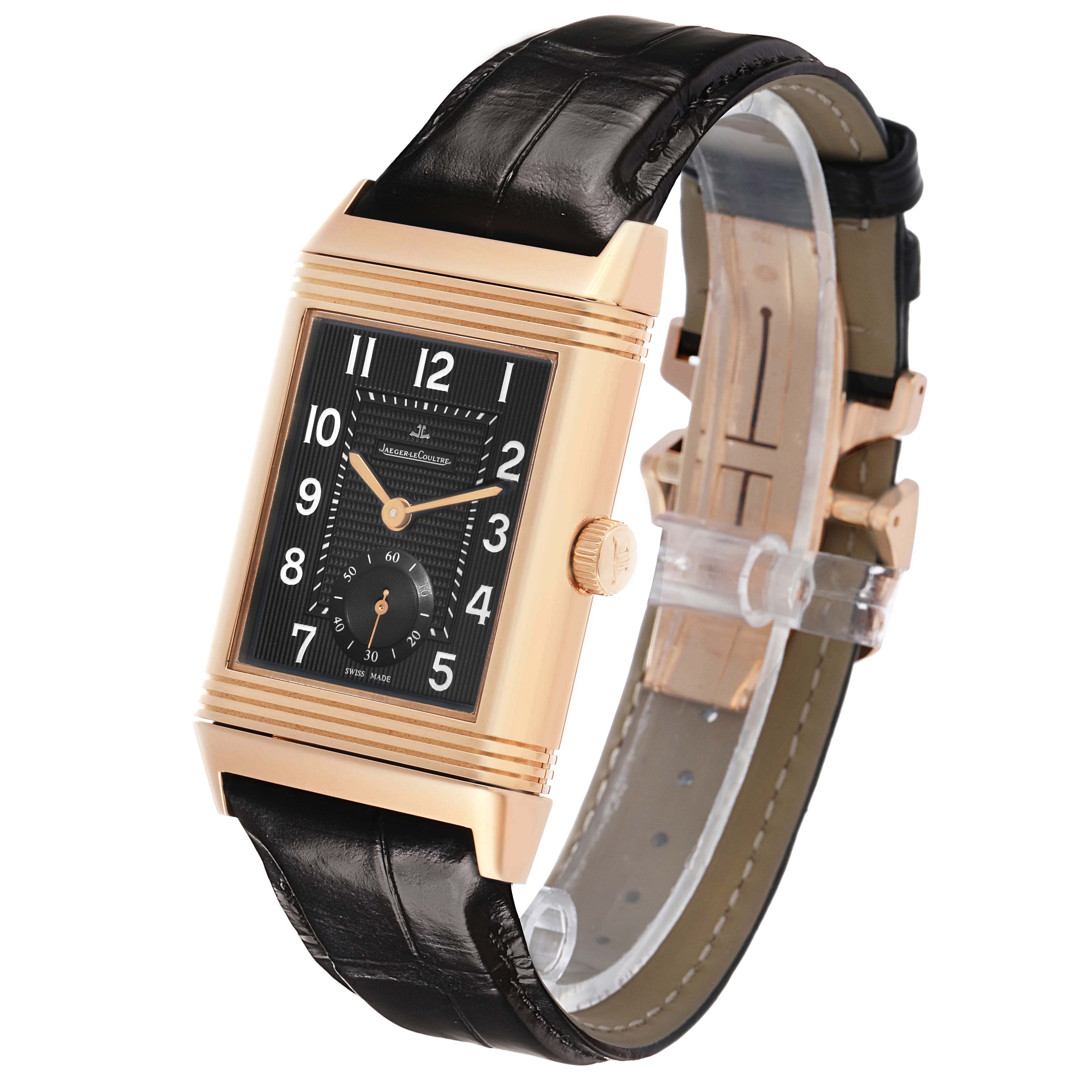 The Jaeger LeCoultre Reverso Q3732470 Men's Rose Gold Black Dial watch is shown at a three-quarter angle, highlighting the black dial, gold case, and black leather strap.