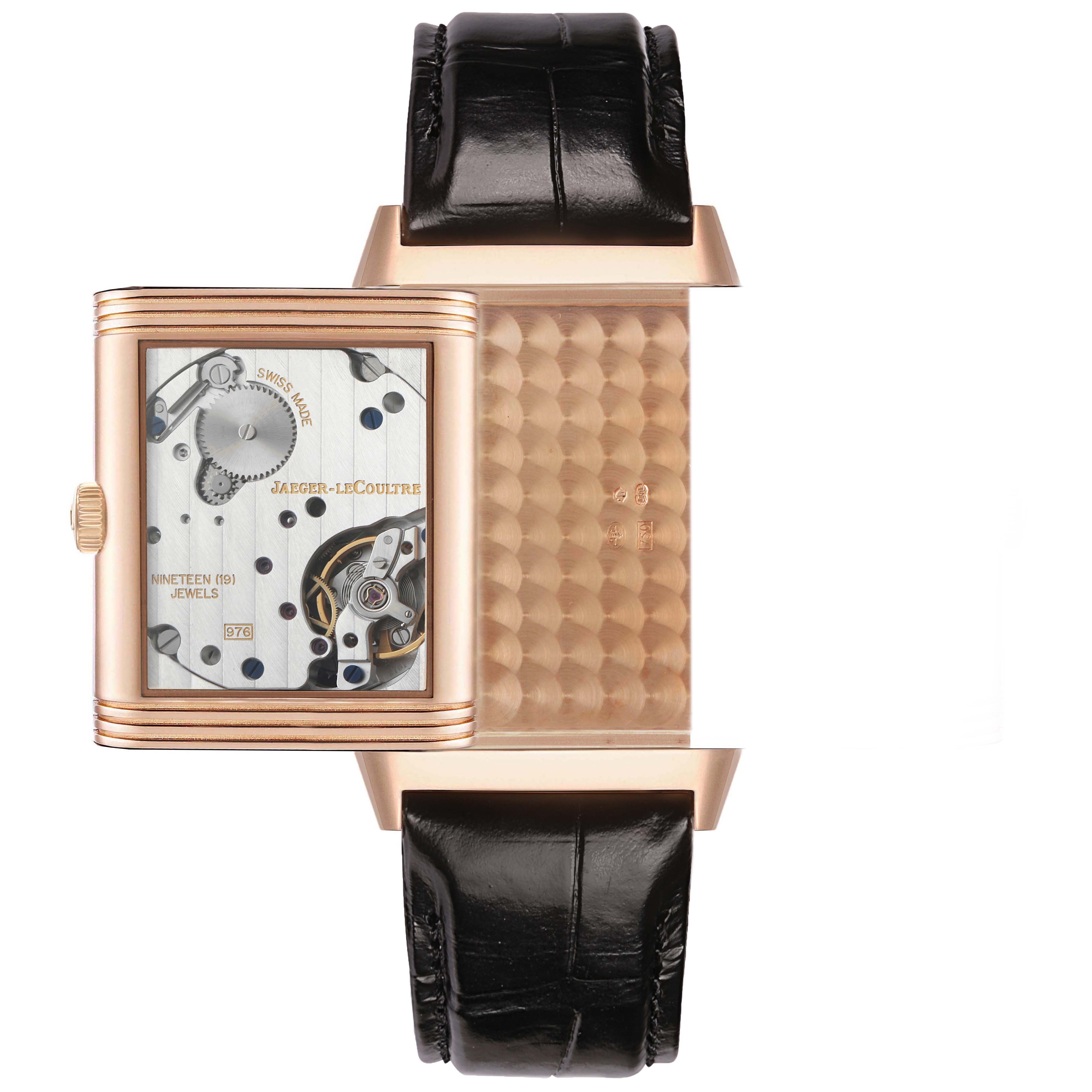 The image shows the Jaeger-LeCoultre Reverso watch with its case open, revealing the movement and decorative backside.