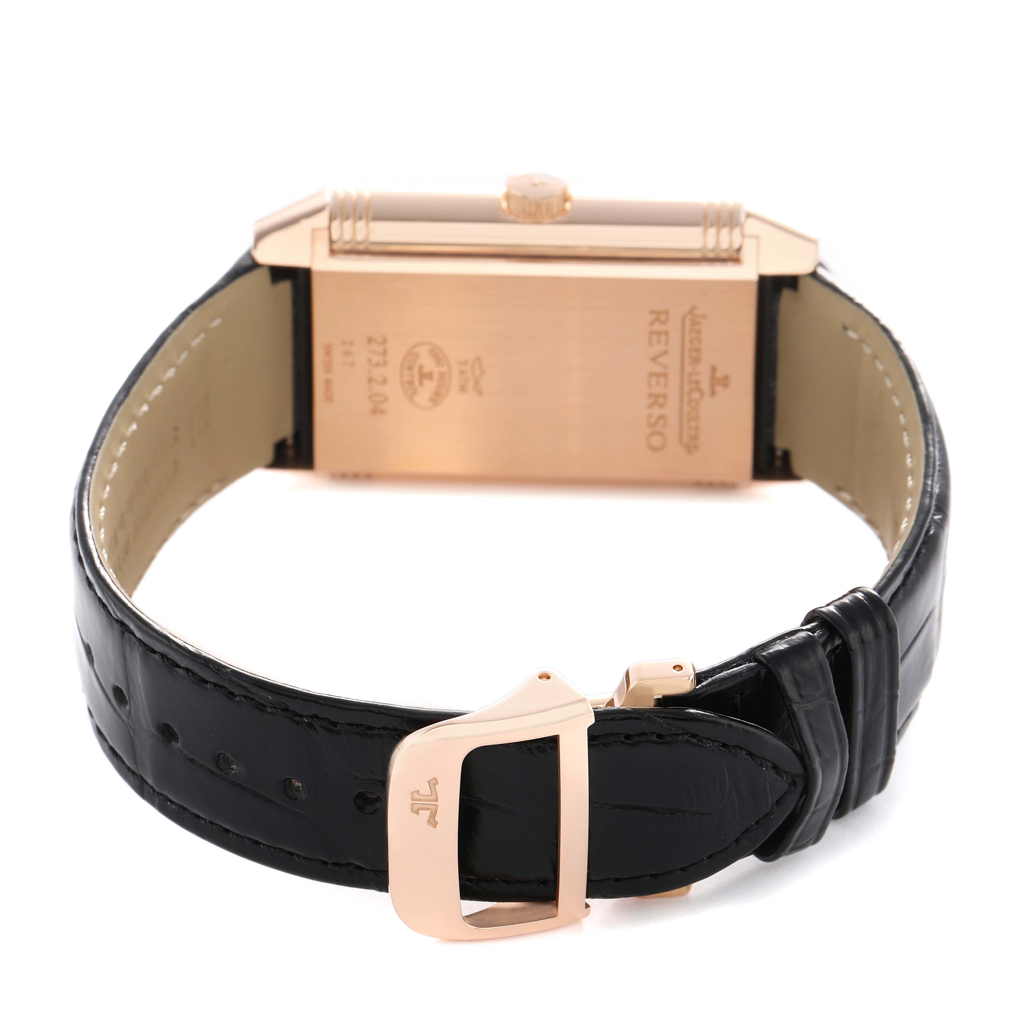 The image shows the back of the Jaeger LeCoultre Reverso Q3732470 Men's Rose Gold Black Dial watch and part of the clasp of its leather strap.