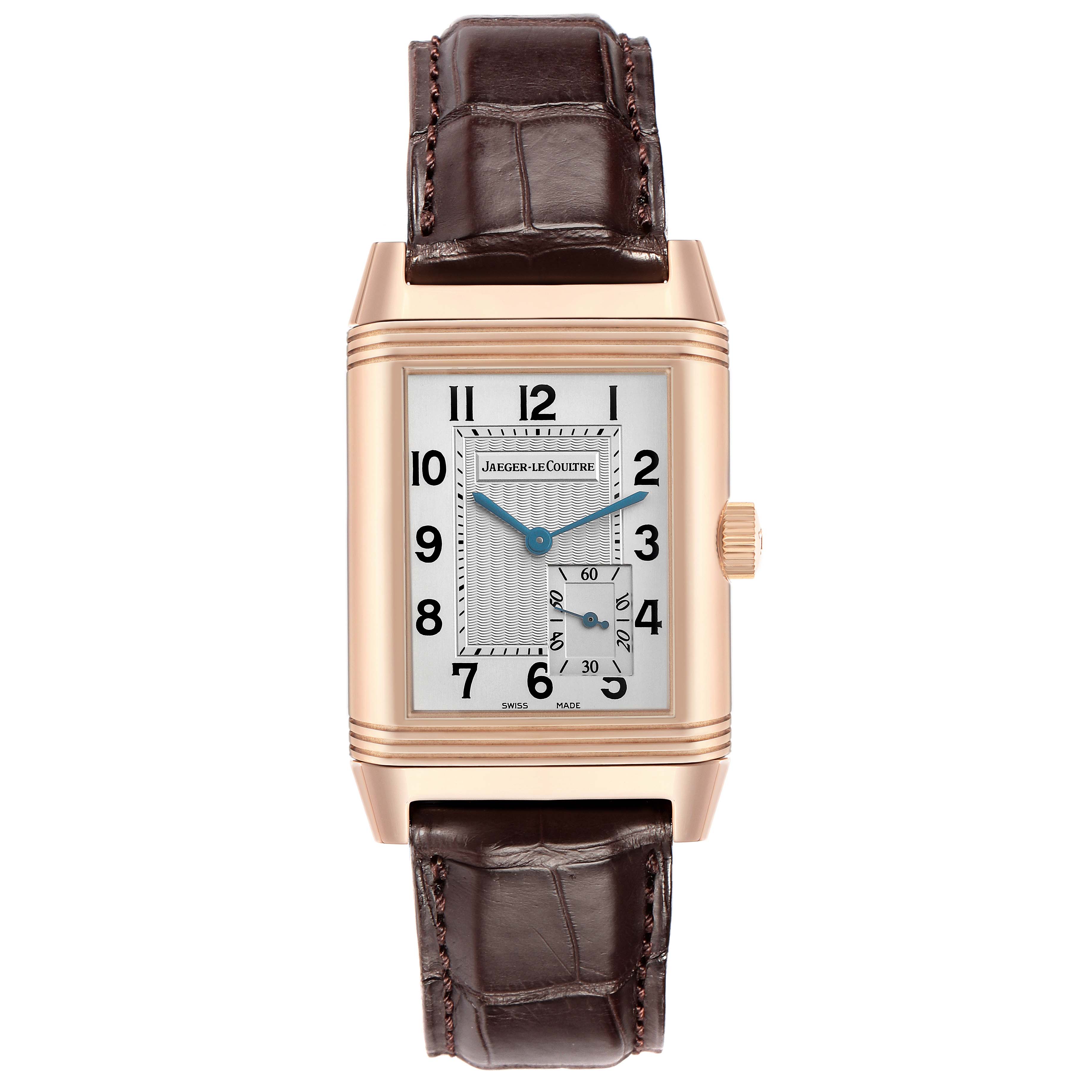 The Jaeger-LeCoultre Reverso watch is shown in a front view, featuring the dial, case, crown, and leather strap.