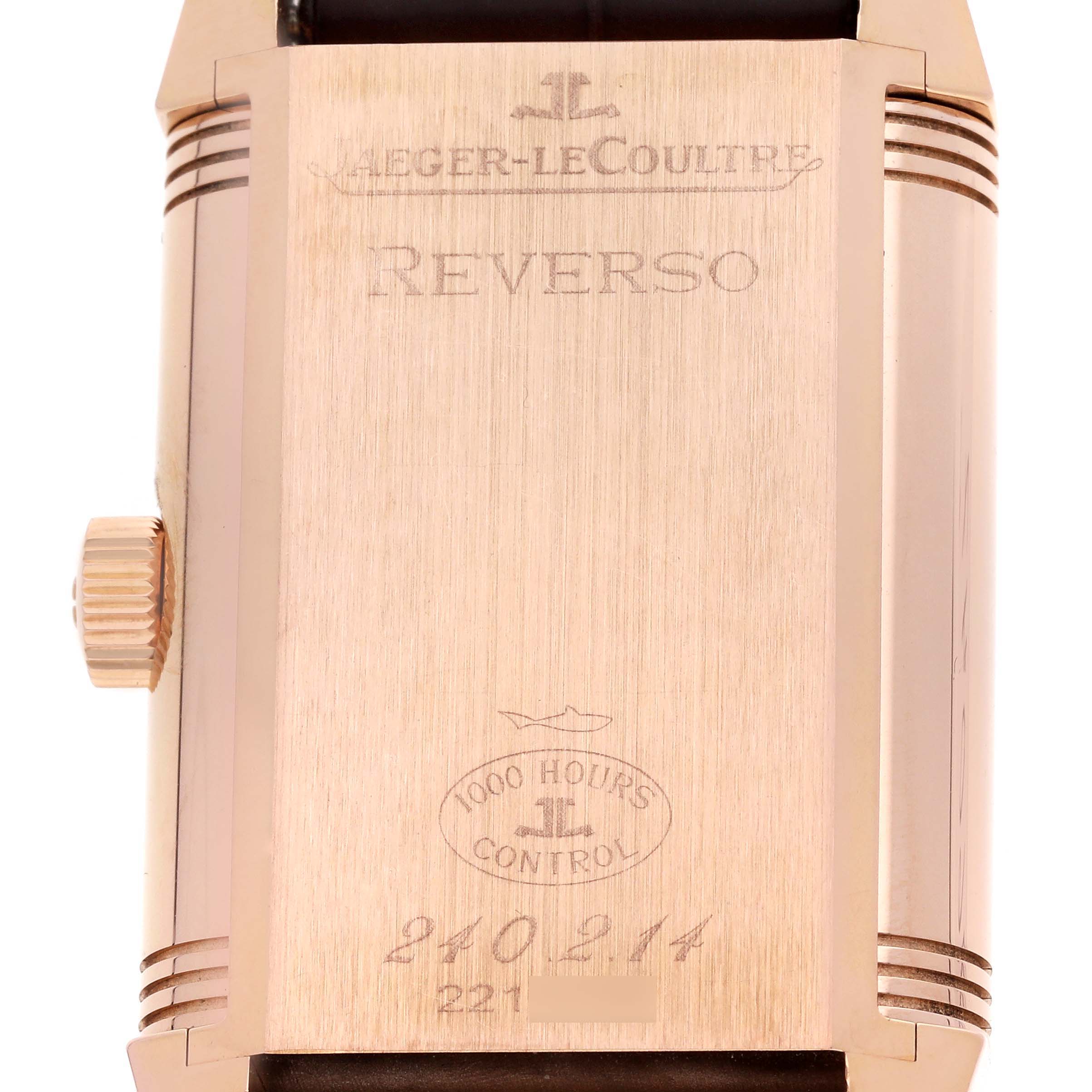 The image shows the back of a Jaeger-LeCoultre Reverso watch, highlighting the engraved details and crown side view.