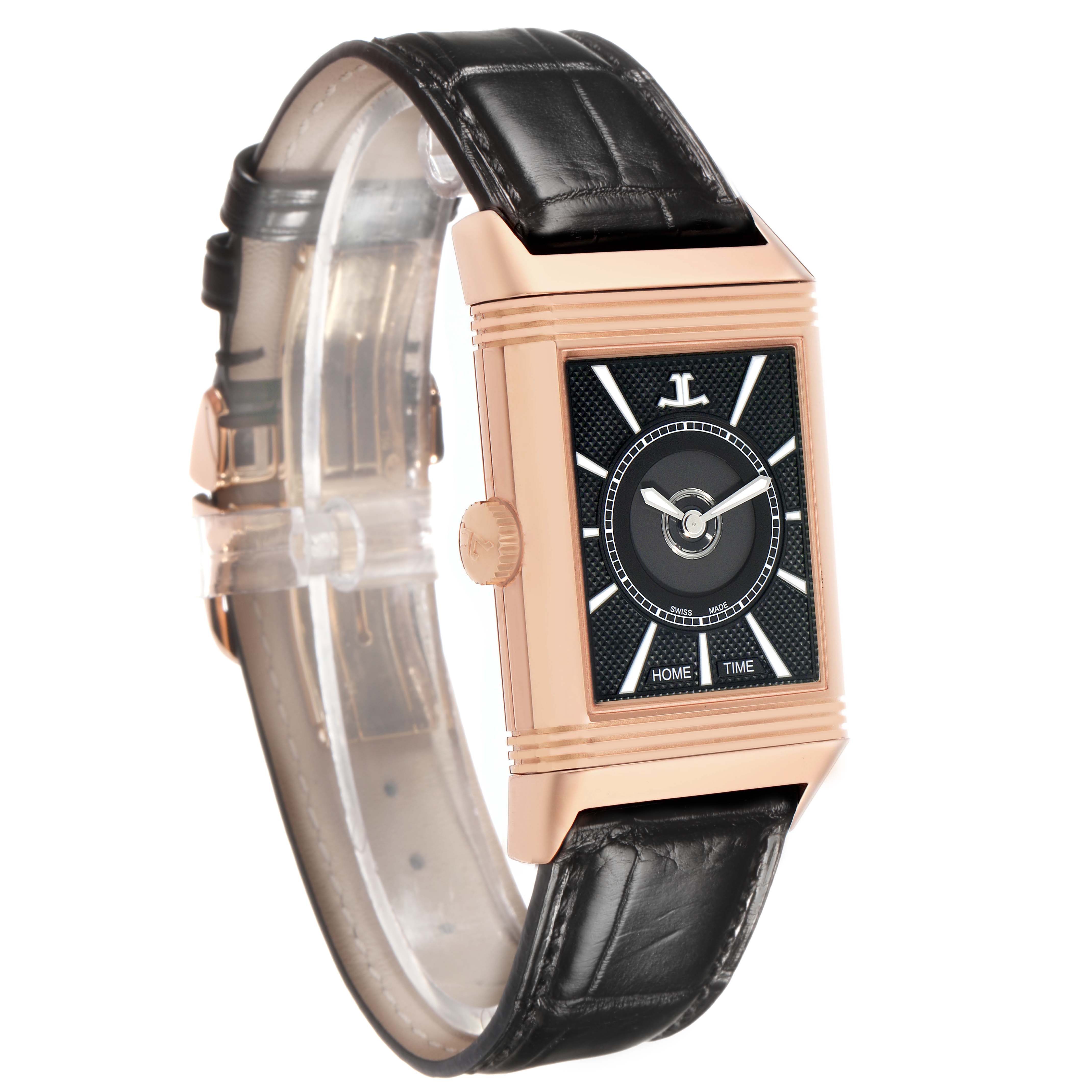 The Jaeger-LeCoultre Reverso watch is shown at a slight angle, highlighting its black dial, rectangular case, crown, and leather strap.
