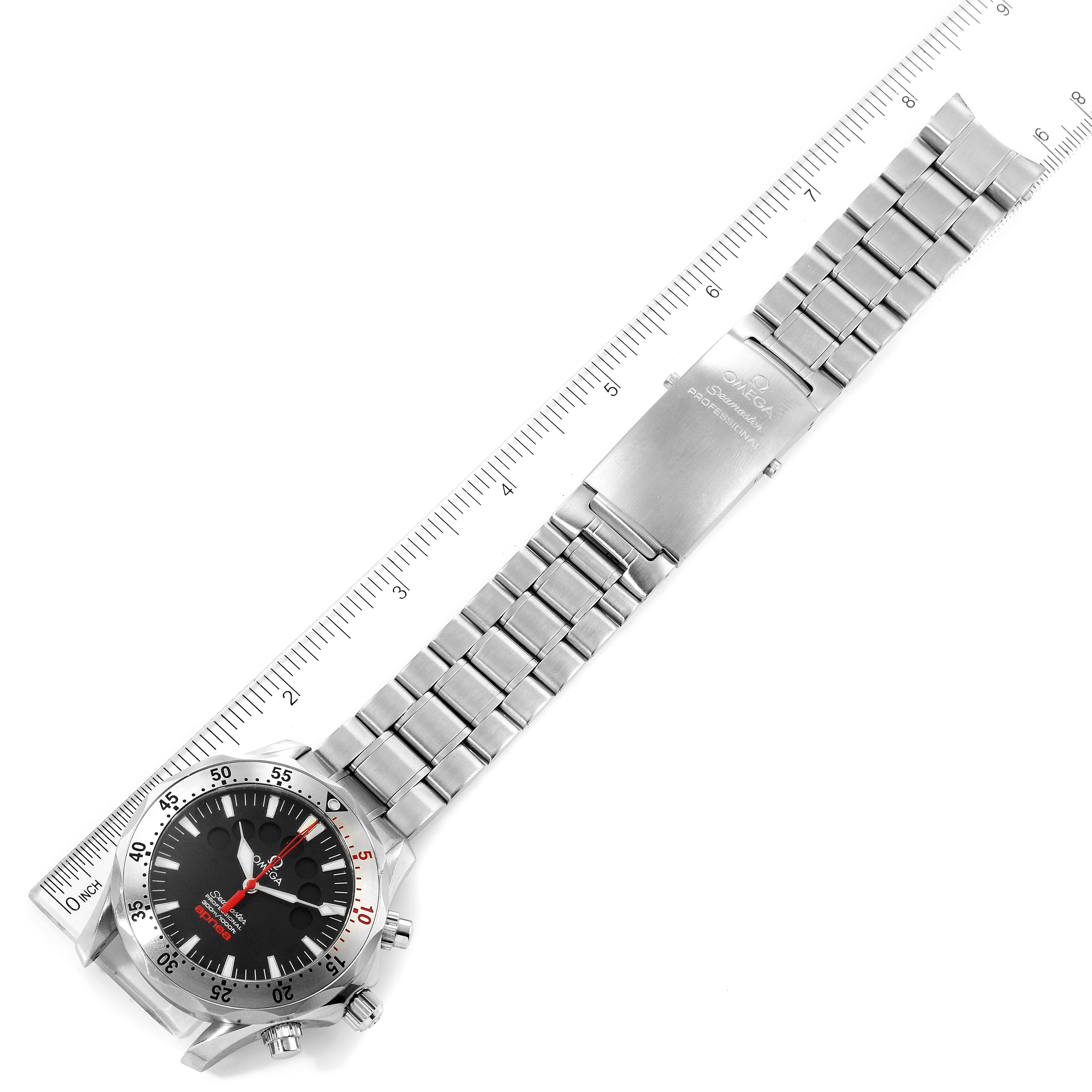 The Omega Seamaster 2595.50.00 Men's Stainless Steel Black Dial 2595.50.00 Men's Stainless Steel Black Dial watch is shown laid flat with the dial, bracelet, and clasp fully visible next to a measuring ruler.