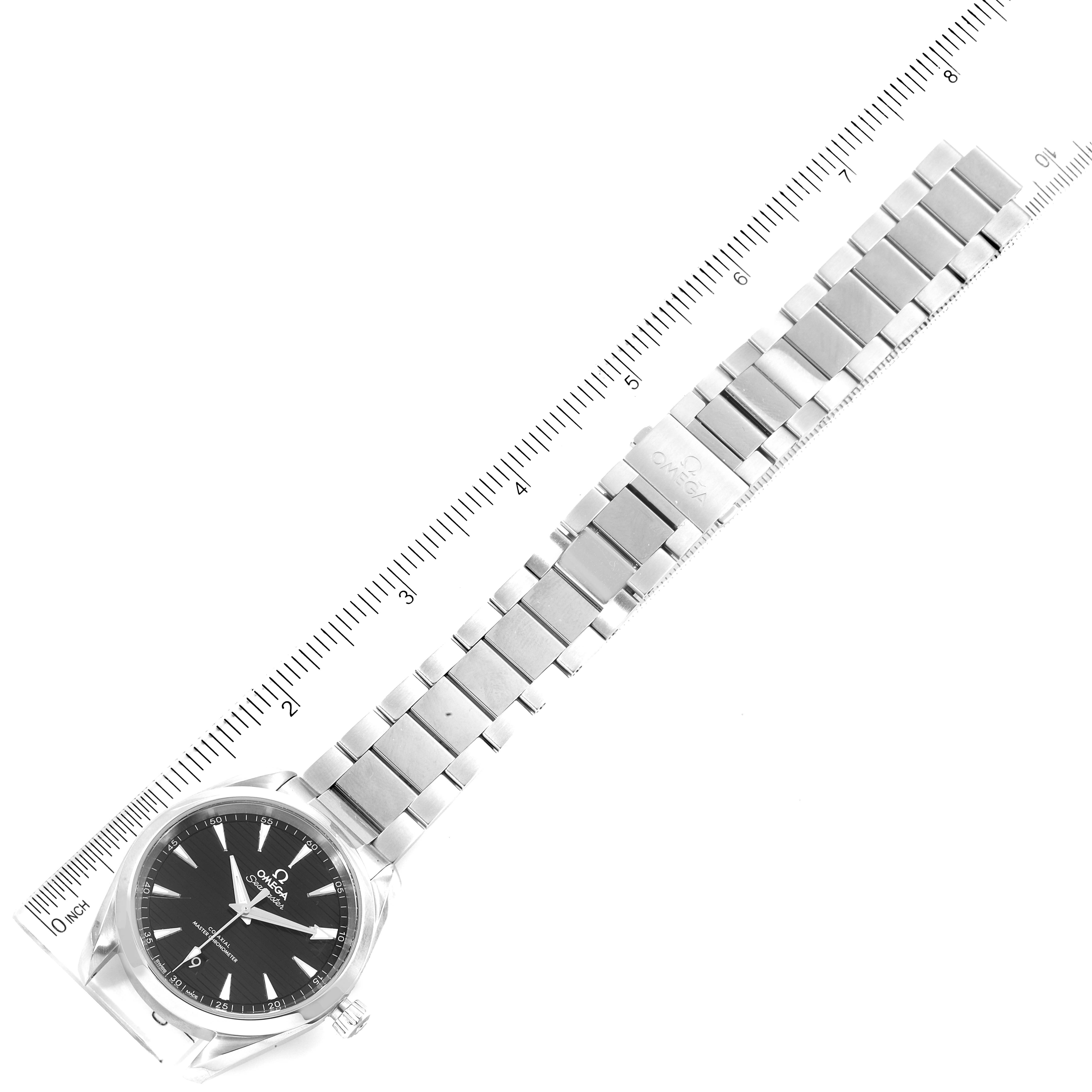 The image shows an Omega Aqua Terra 220.10.38.20.01.001 Men's Stainless Steel Black Dial 220.10.38.20.01.001 Men's Stainless Steel Black Dial watch from a top-down angle, including the face, bracelet, and a measuring ruler beside it.