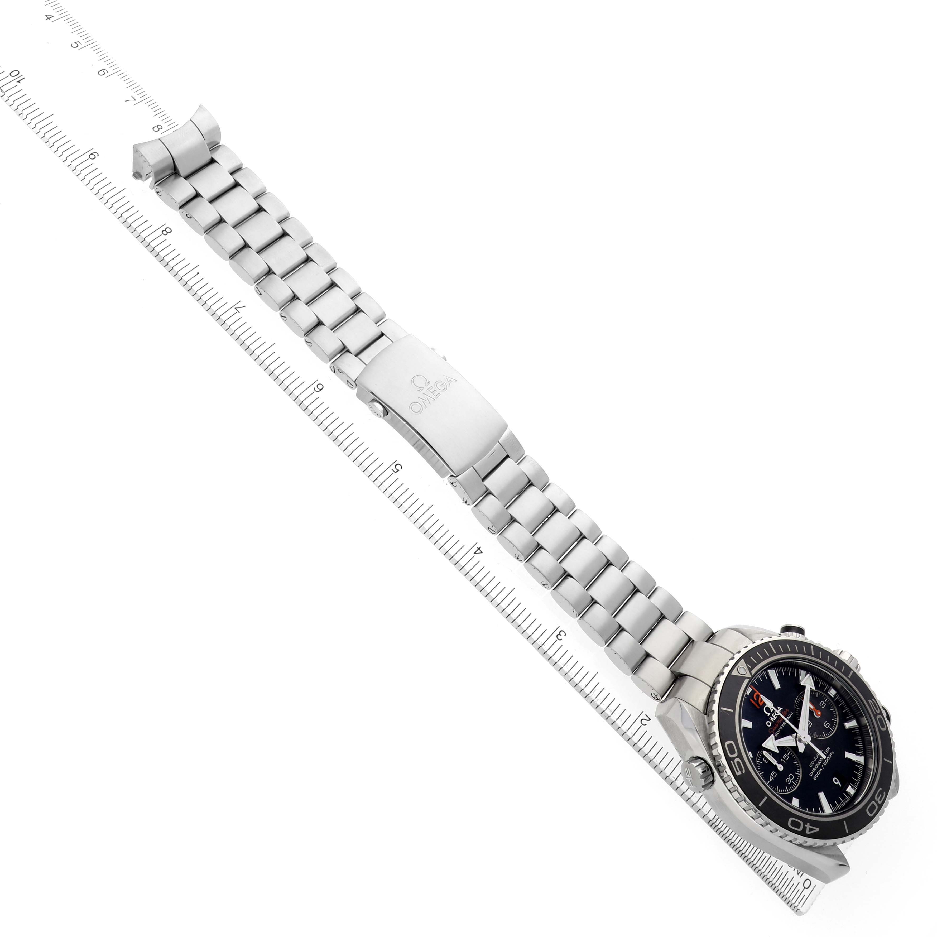 The image shows the Omega Planet Ocean 232.30.46.51.01.003 Men's Stainless Steel Black Dial watch at an angled top view, highlighting the bracelet and clasp along with the watch face.