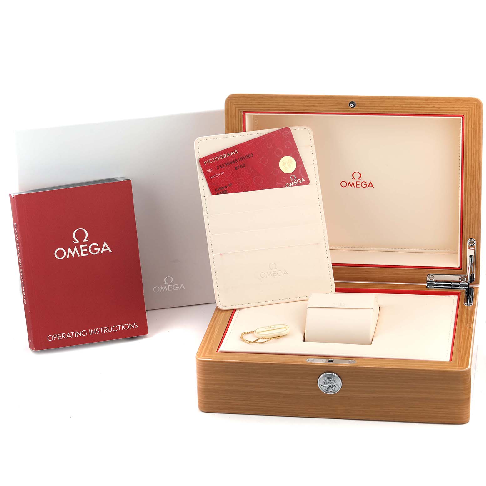 The image displays the Omega Planet Ocean 232.30.46.51.01.003 Men's Stainless Steel Black Dial's wooden box, warranty cards, instruction manual, and cardholder from a top angle.