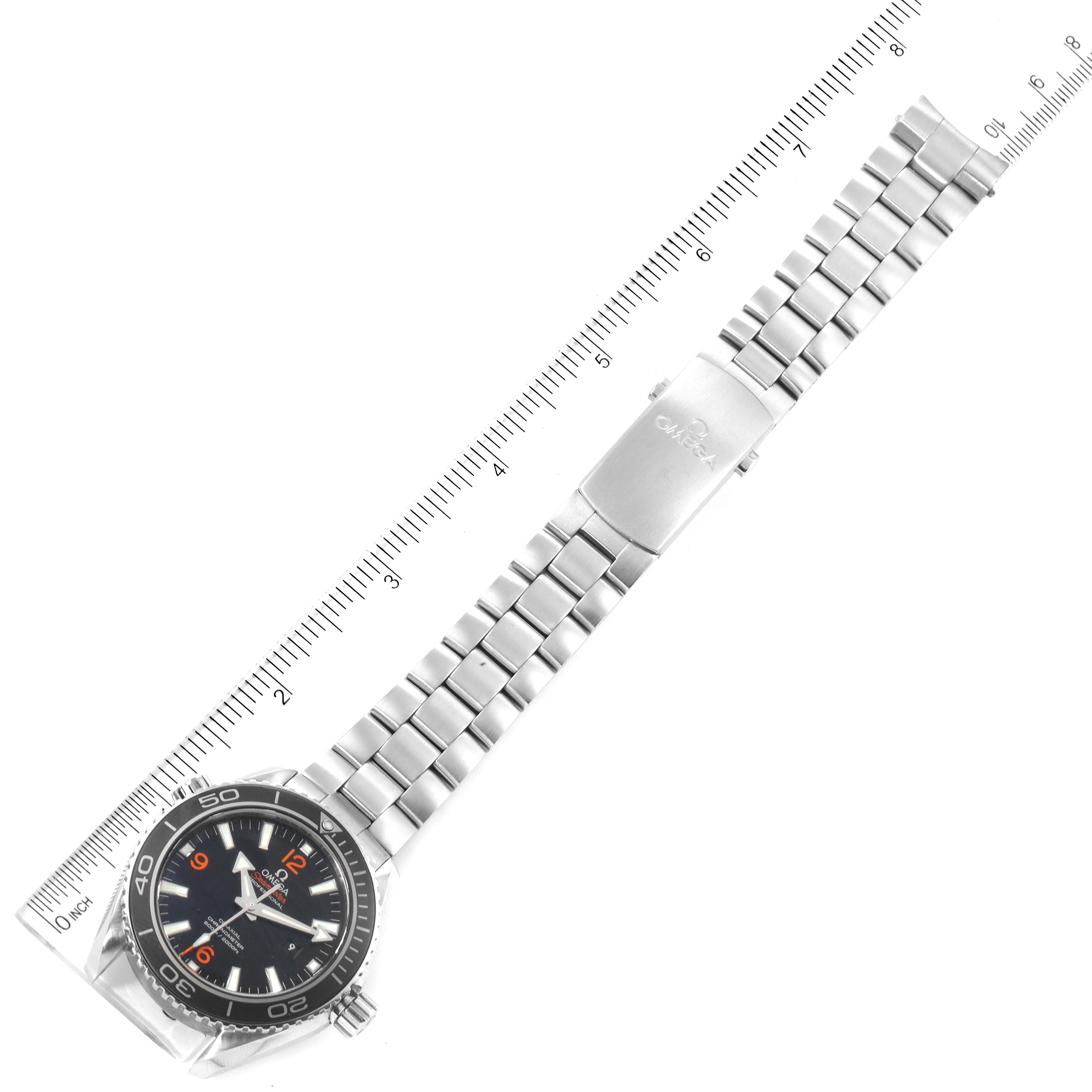 The image shows an Omega Planet Ocean 232.30.38.20.01.002 Men's Stainless Steel Black Dial 232.30.38.20.01.002 Men's Stainless Steel Black Dial watch laid flat, revealing its face, bracelet, and clasp next to a ruler for size reference.