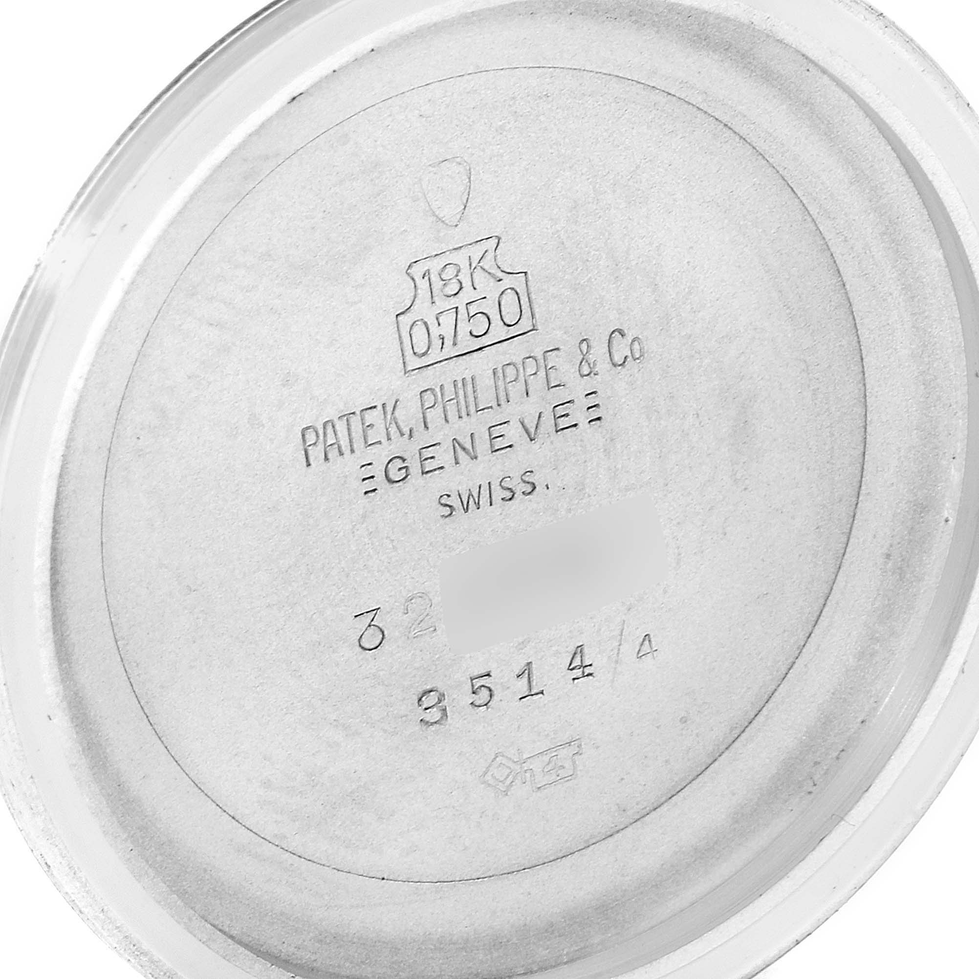 This image shows the inside back cover of a Vintage Patek Philippe watch, displaying inscriptions and hallmarks.