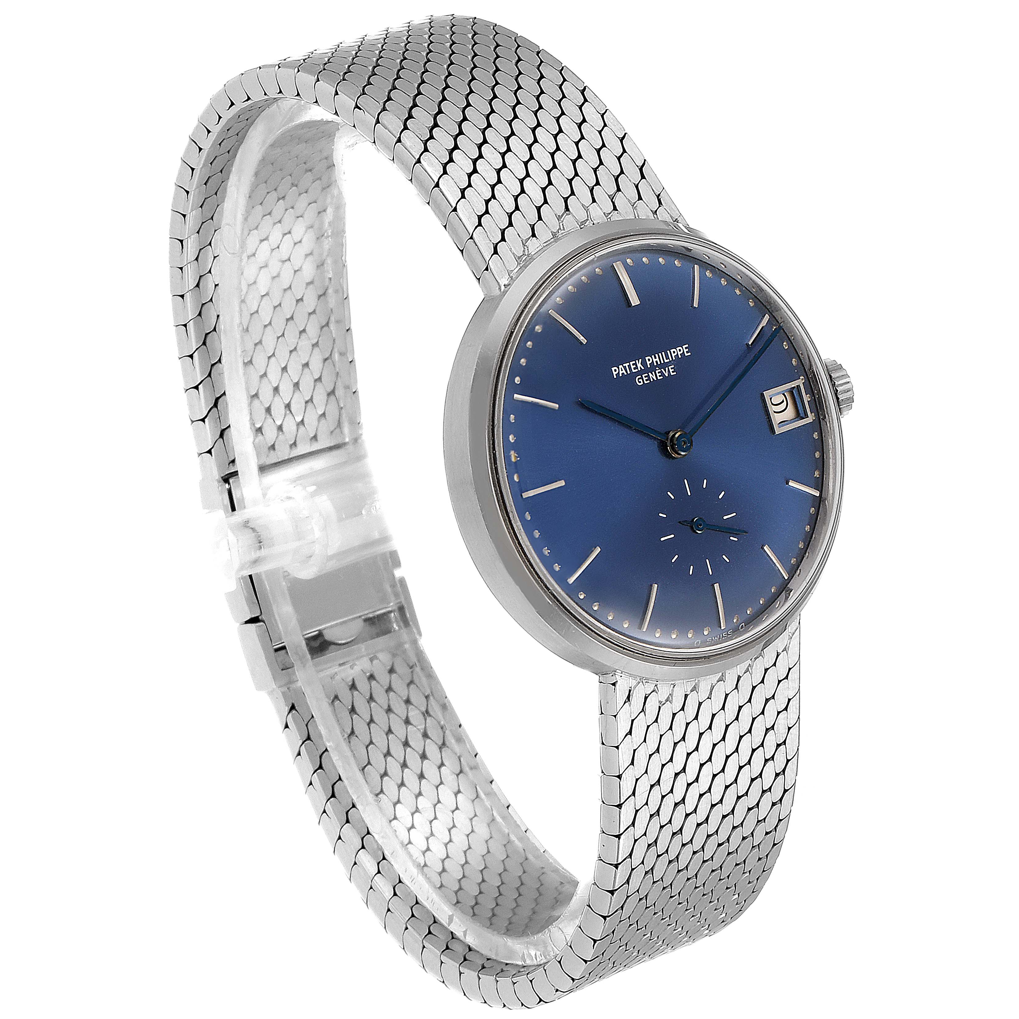 The image shows a side angle of a Vintage Patek Philippe watch with a blue dial, a date window, and a silver mesh band.
