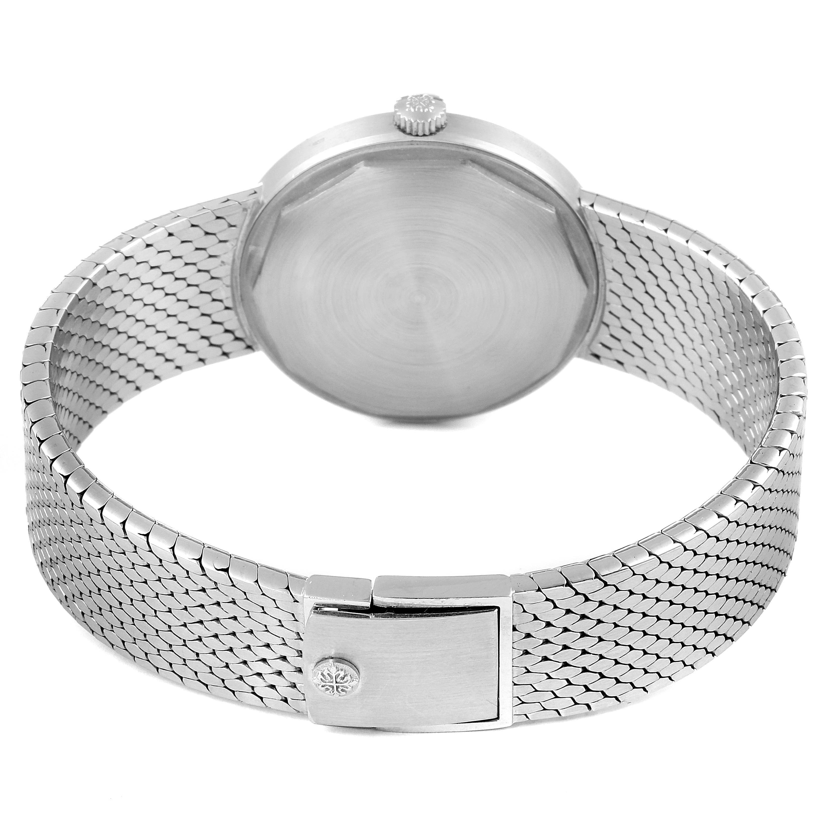 This image shows the back view of a Vintage Patek Philippe watch, highlighting the case back, crown, and metal bracelet.