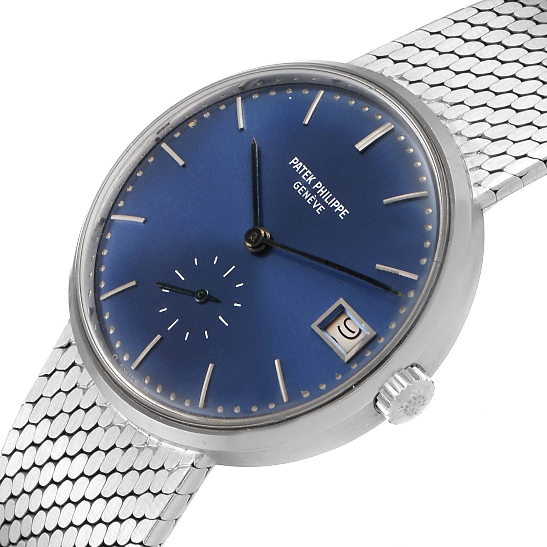 This image shows the face, crown, and partial bracelet of a Vintage Patek Philippe watch from an angled view.