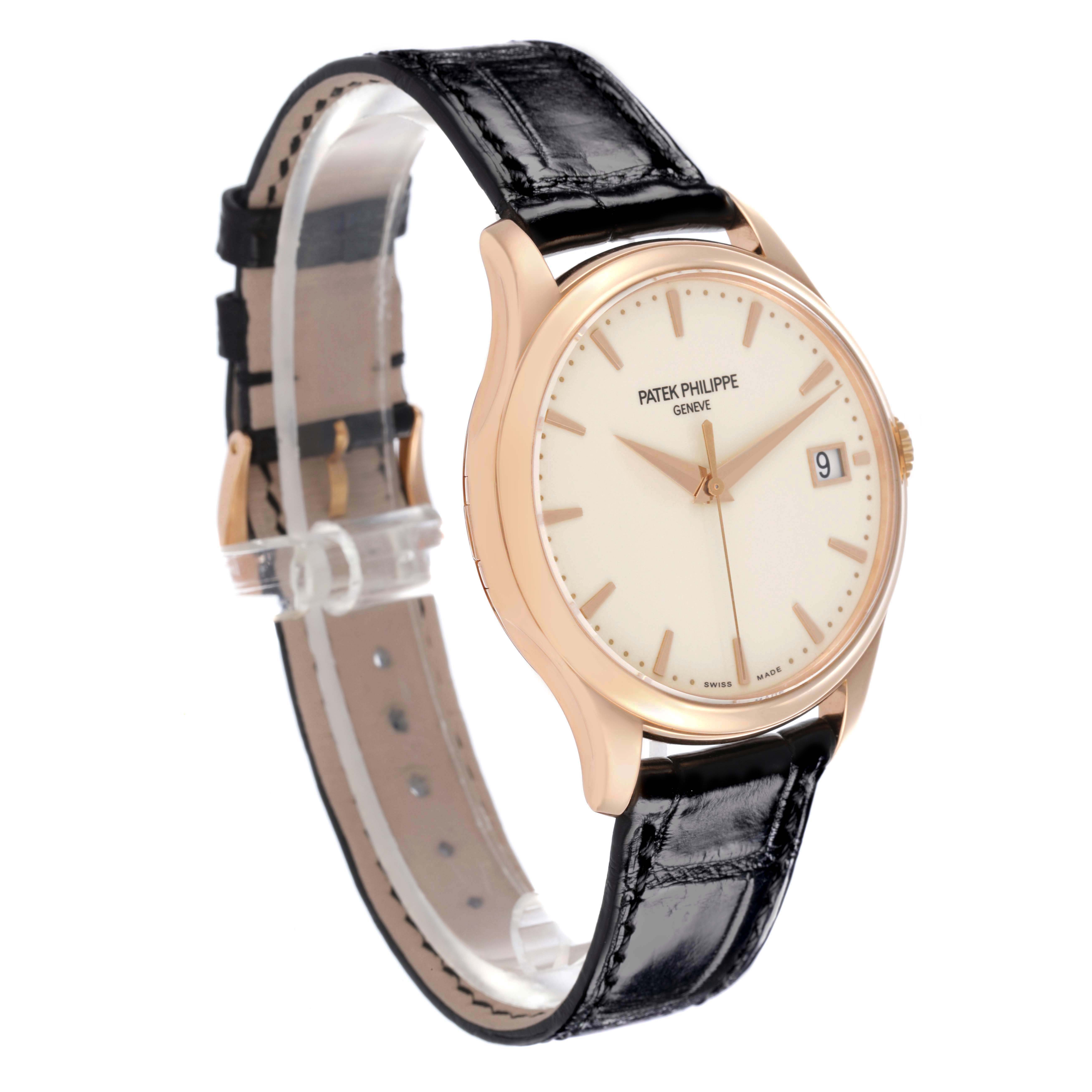 The Patek Philippe Calatrava 5227R-001 Men's Rose Gold Beige Dial watch is shown at a three-quarter angle, featuring the case, dial, date display, and leather strap.