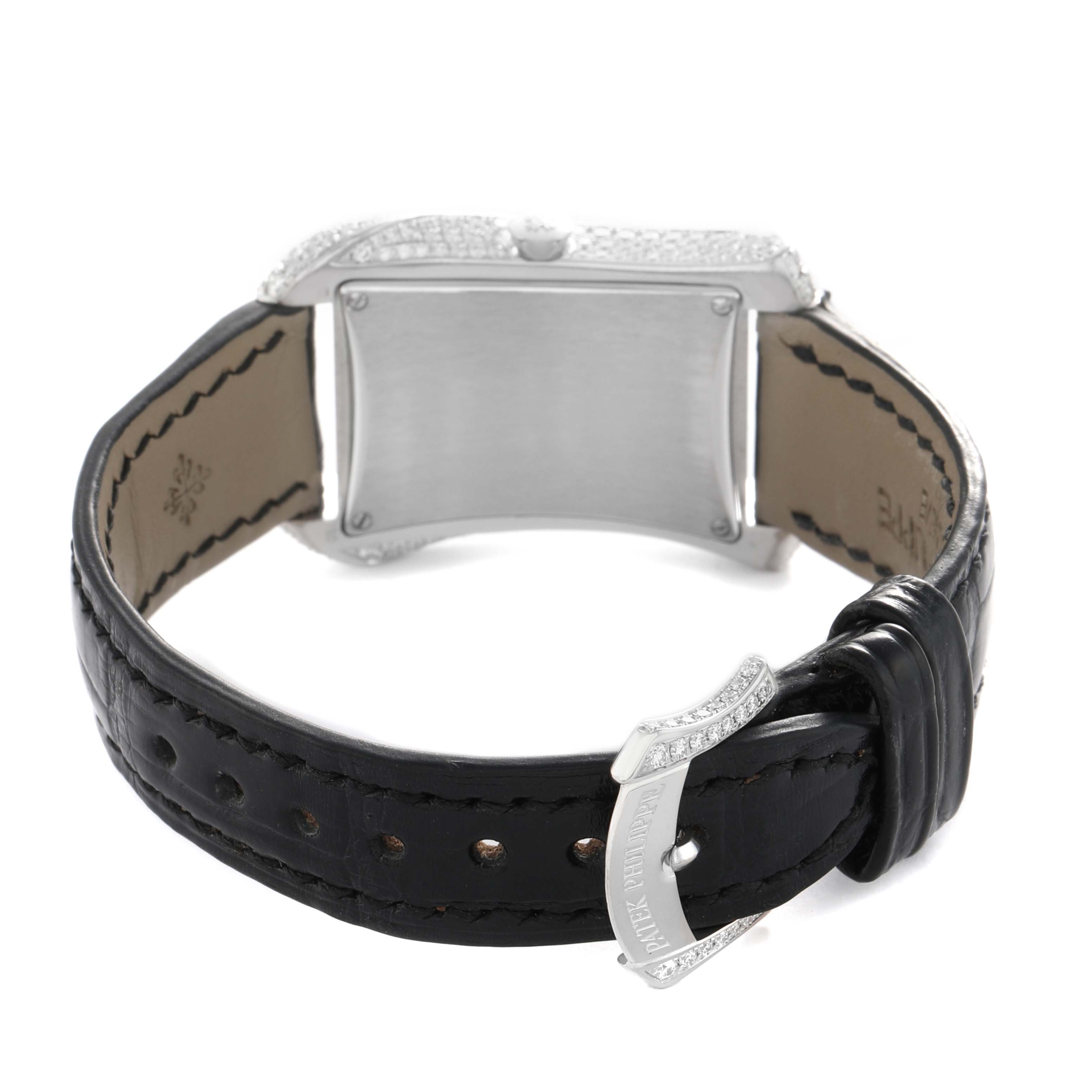 The Patek Philippe Gondolo 4973G Women's White Gold Mother of Pearl Dial watch is shown from the back, highlighting the clasp, case back, and black leather strap.