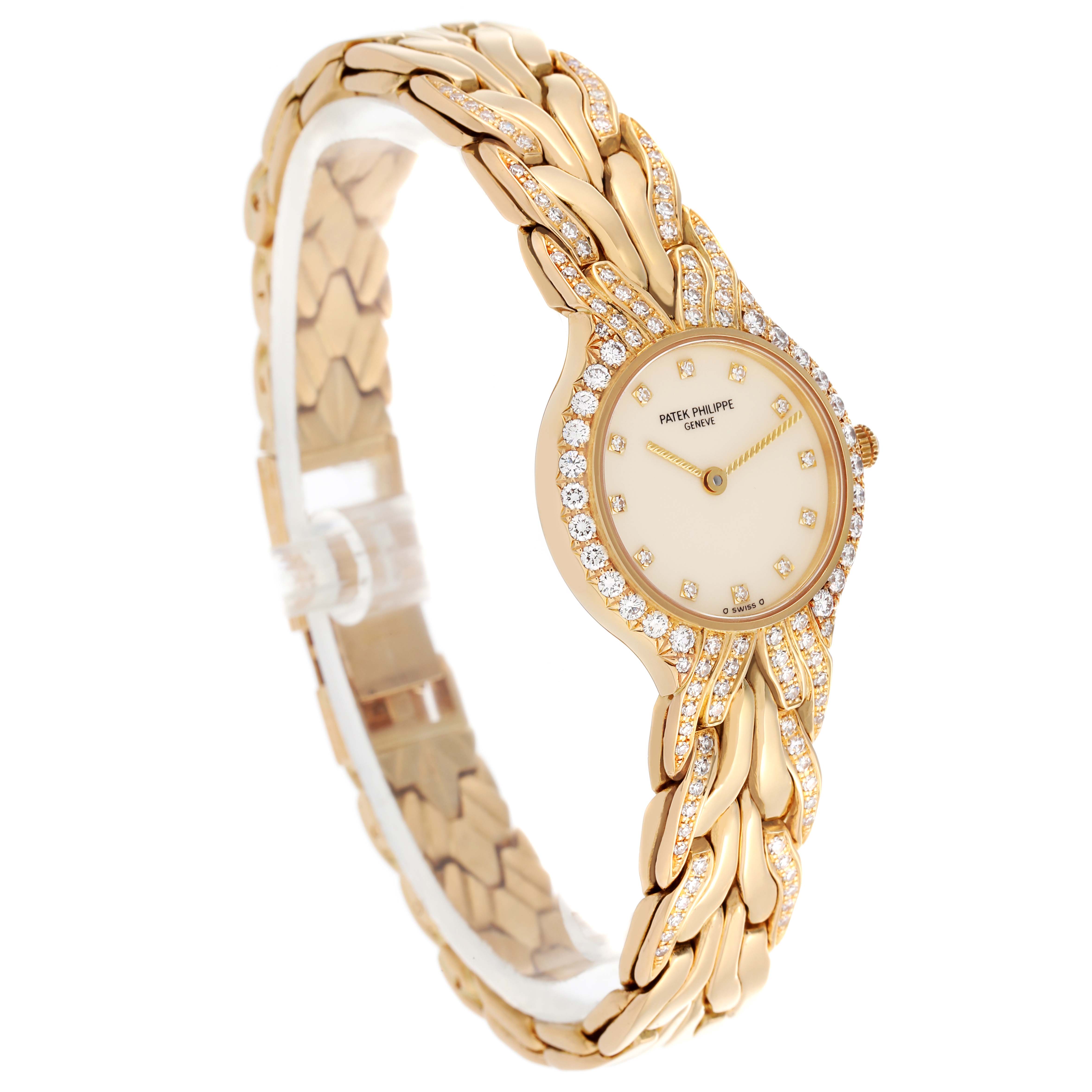 The La Flamme model by Patek Philippe is shown from an angled side view, highlighting the diamond-studded bezel and gold bracelet.