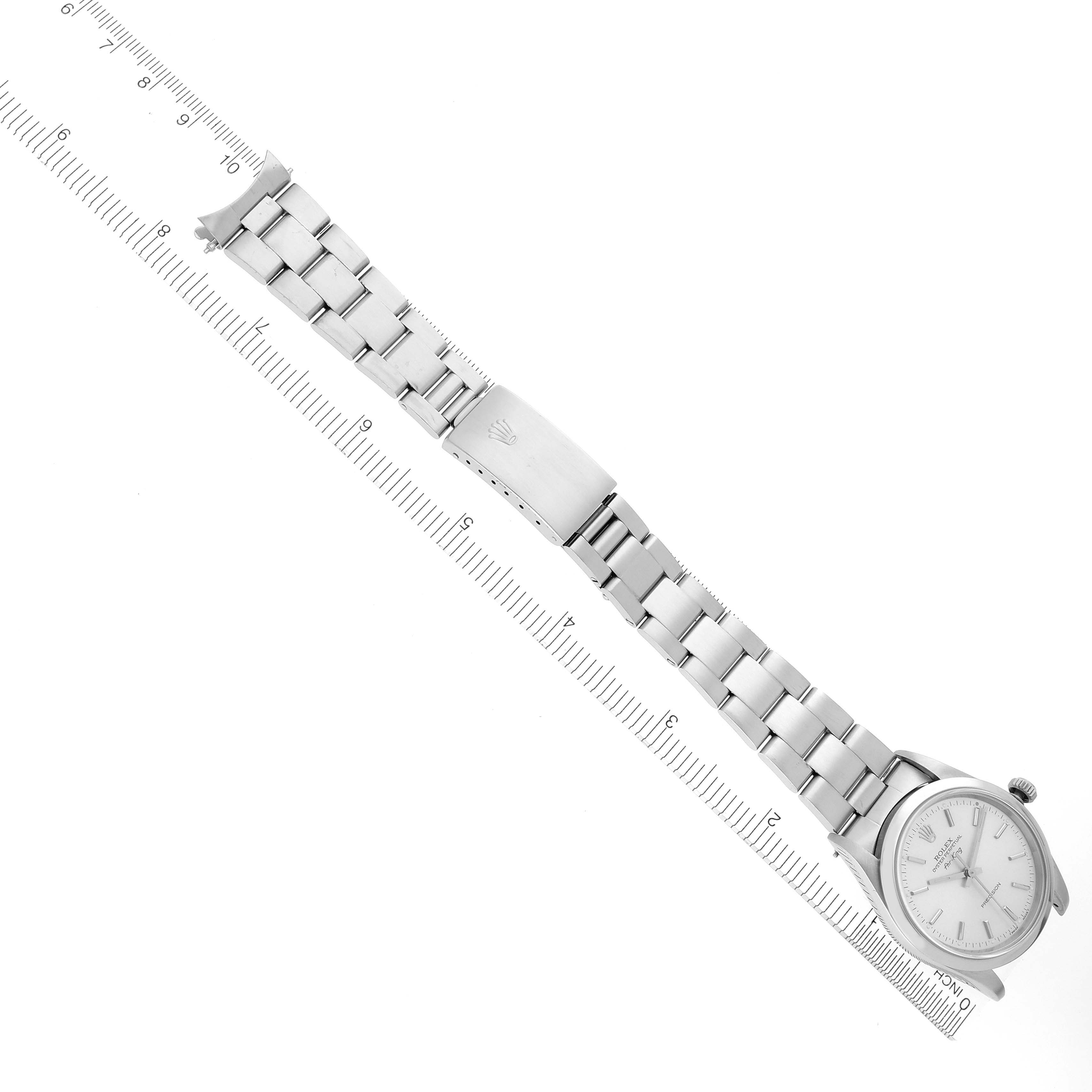 The Rolex Air-King 14000 Men's Stainless Steel Silver Dial 14000 Men's Stainless Steel Silver Dial watch is displayed from a top view, showing the entire band and face alongside a ruler for scale.