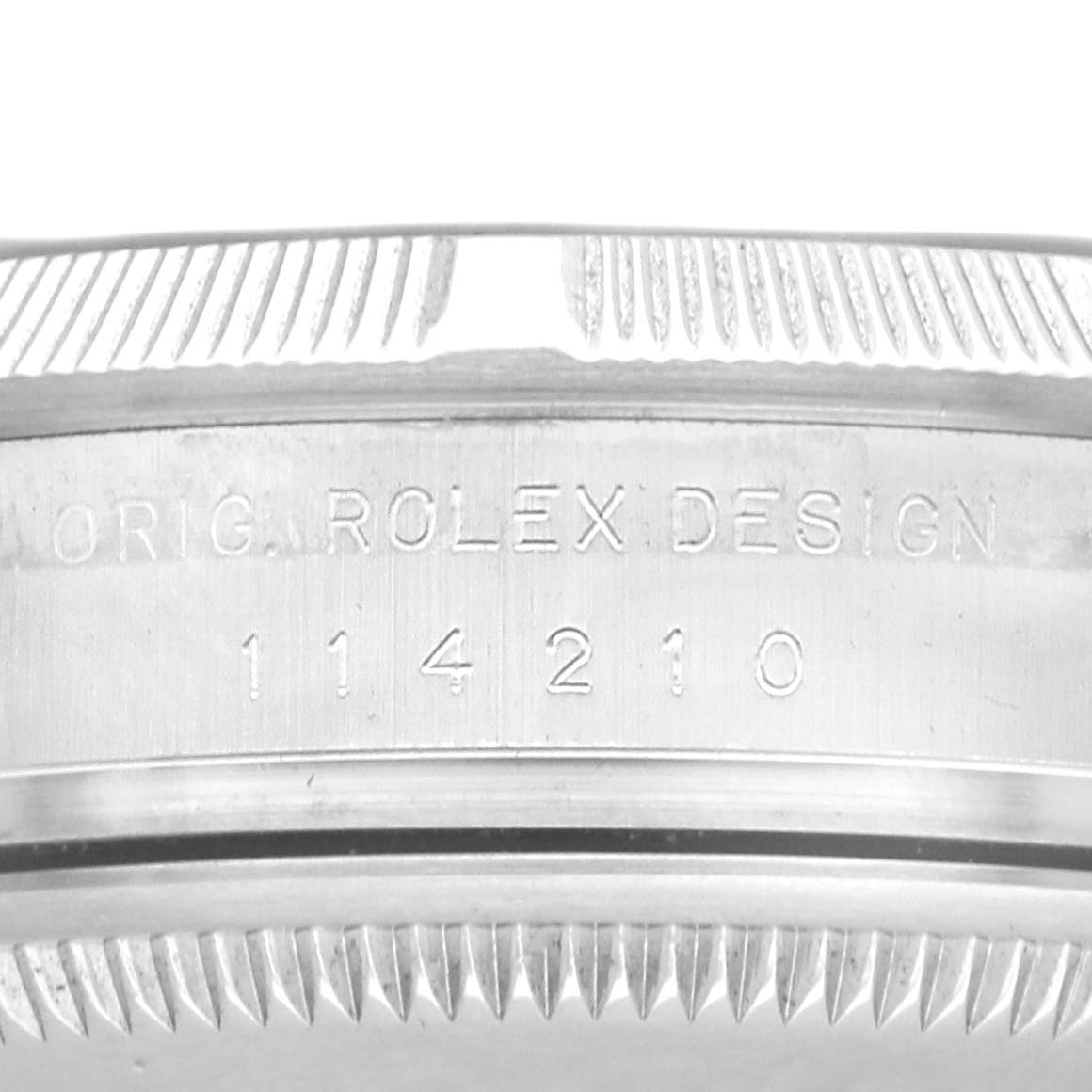 The image shows a close-up of the side of a Rolex Air-King 114210 Men's Stainless Steel Pink Dial watch, highlighting the engraving with model number and brand name.