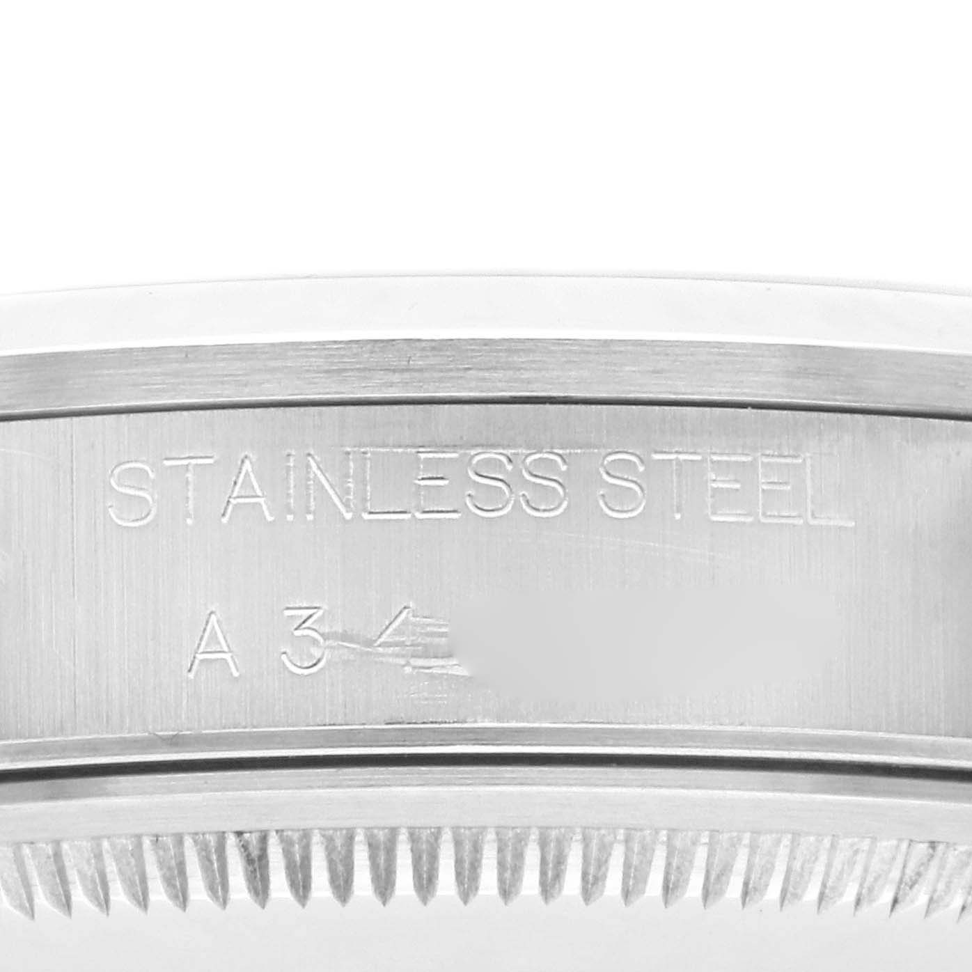 The image shows a close-up of the stainless steel case of a Rolex Air-King 14000 Men's Stainless Steel White Dial 14000 Men's Stainless Steel White Dial watch, featuring engraved details.