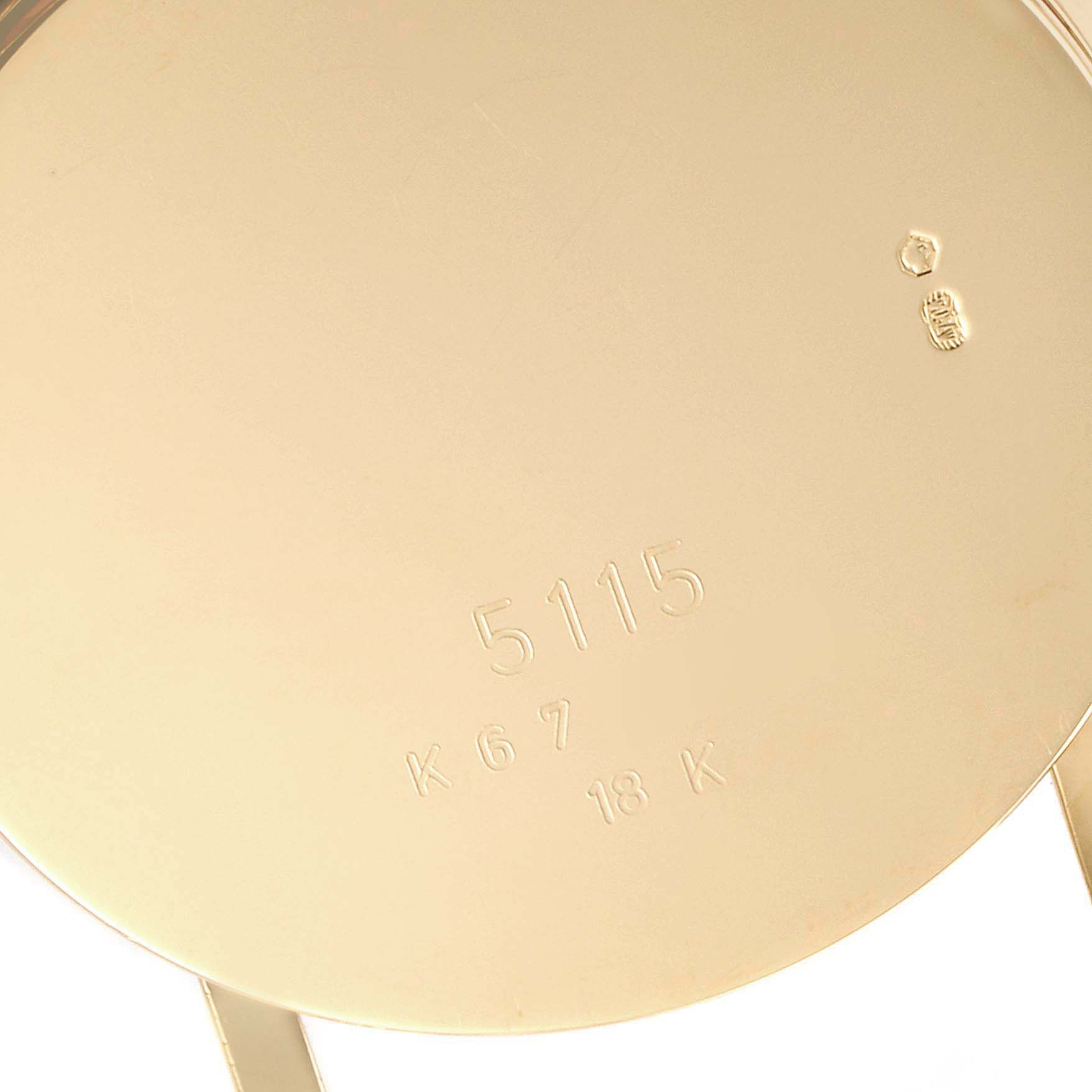 This image shows the back case of a Rolex Cellini 5115 Men's Yellow Gold Beige Dial 5115 Men's Yellow Gold Beige Dial model watch with engravings and hallmarks, viewed from a close-up angle.