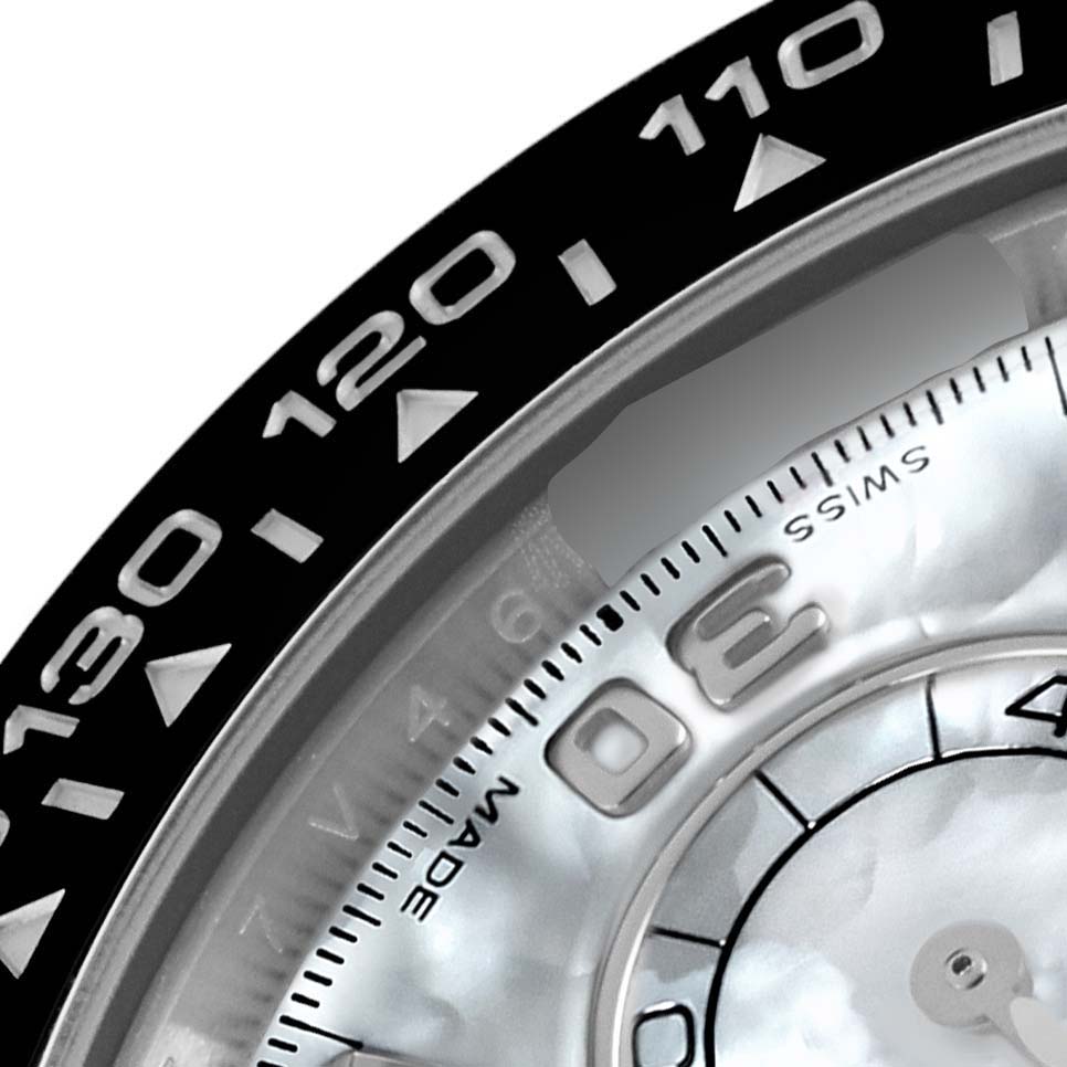 The image shows a close-up of a Rolex Daytona 116519LN Men's White Gold Mother of Pearl Dial 116519LN Men's White Gold Mother of Pearl Dial watch bezel with engraved numbers and part of the dial.