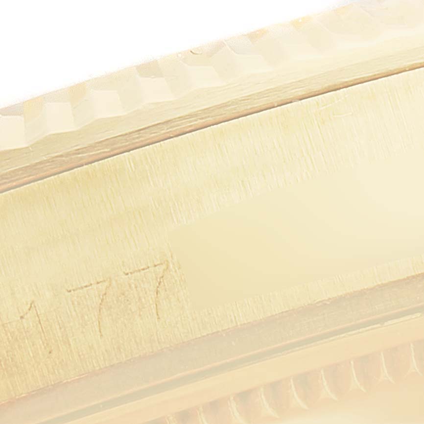 This close-up image of a Rolex President 1503 Men's Yellow Gold Champagne Dial 1503 Men's Yellow Gold Champagne Dial model watch shows the edge of the case and part of the fluted bezel.