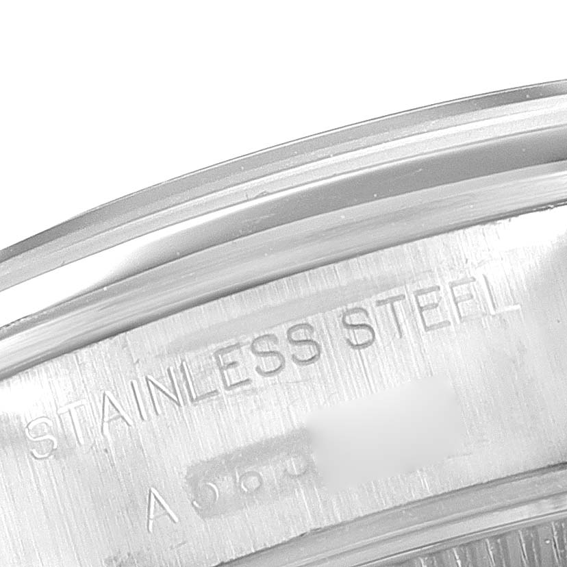 The image shows a close-up of the case back of a Rolex Date 69160 Women's Stainless Steel Black Dial 69160 Women's Stainless Steel Black Dial model, highlighting the "STAINLESS STEEL" engraving.