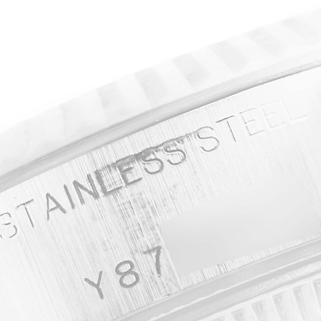 This close-up image shows the "Stainless Steel" inscription and part of the serial number on the side case of a Rolex Datejust 79174 Women's Stainless Steel Mother of Pearl Dial 79174 Women's Stainless Steel Mother of Pearl Dial watch.